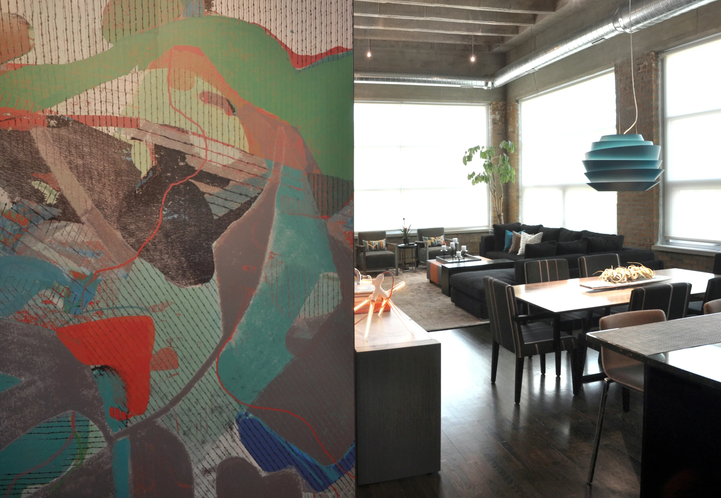 Creating this modern interpretation of a bachelor pad was pure fun! By first developing a neutral backdrop, we were able to imbue the space with an incredible amount of style through pops of color, custom designed furnishings, and an inspired art collection; including a floor-to-ceiling wall graphic installation by Chicago artist Connie Noyes. Through the aforementioned elements this space was fundamentally transformed from a boring industrial box to an environment built for inspiration and entertaining. What we did: When this particular client approached us, he had already had false-starts with two other interior designers. Through our client-driven process, we finalized space plans, selected thoughtful furnishings, designed custom pieces, and curated a full art collection of both local and nationally-recognized artists. 