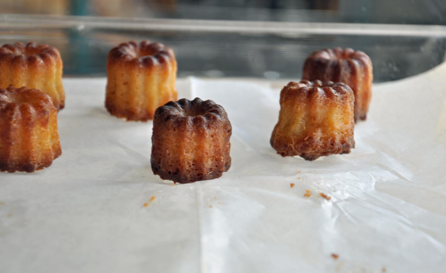 CANELE - THE ORIGIN OF THIS CONFECTION DATES BACK TO A CONVENT IN THE BORDEAUX REGION OF FRANCE BEFORE THE FRENCH REVOLUTION. NUNS PREPARED THE LITTLE CAKE FOR ORPHANS. THE BAKERY MAKES THIS UNIQUE PASTRY THAT CARRIES AN AROMA RICH WITH THE FRAGRANCES OF VANILLA, CARAMEL, BEESWAX AND HISTORY.