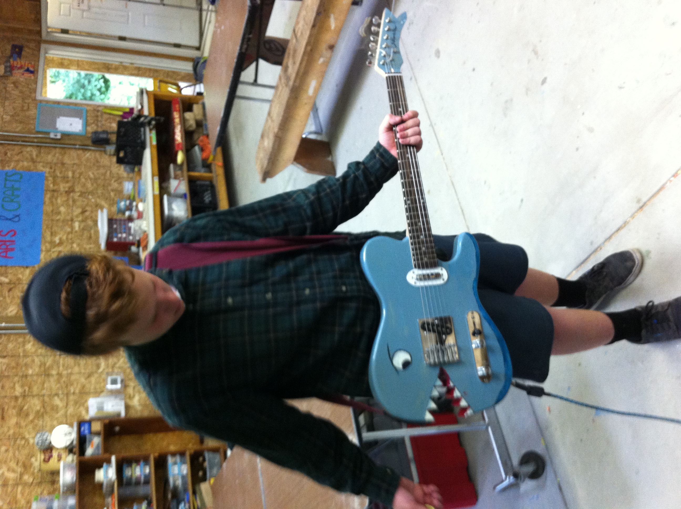 Owen from the hobby holds the strung-up guitar!
