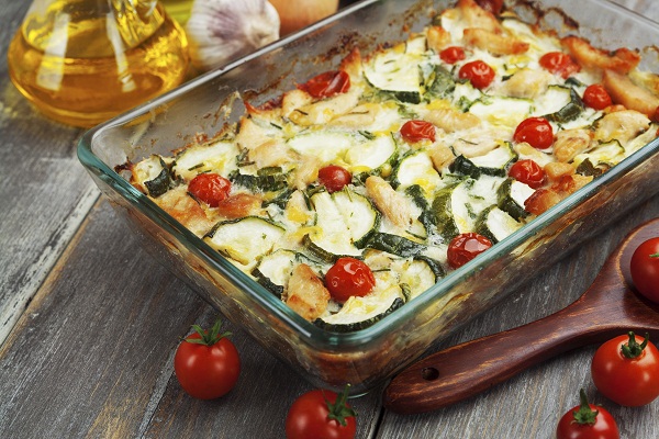 Zucchini baked i with chicken, cherry tomatoes and herbs