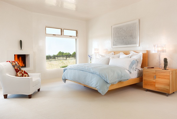 The king-sized bed was made of maple by a local Santa Fe craftsman Christopher Thayer. There is a 1920's Navajo textile over the back of white slip covered chair. Chair was made by Burton James.