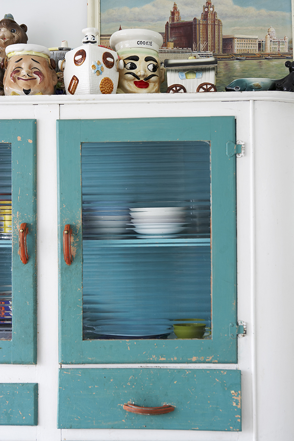 The original ribbed glass door panels and worn paintwork testify to this storage unitβs date and authenticity, while the top is used to display a collection of humorous and vintage ceramics.