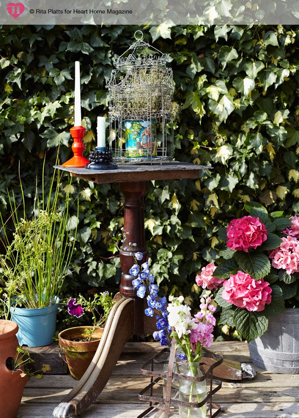 Lots of clever tricks have been used to add height within this garden: here, a discarded table leg, found on the street outside, has been topped with a slate roof tile to create a quirky plant stand.