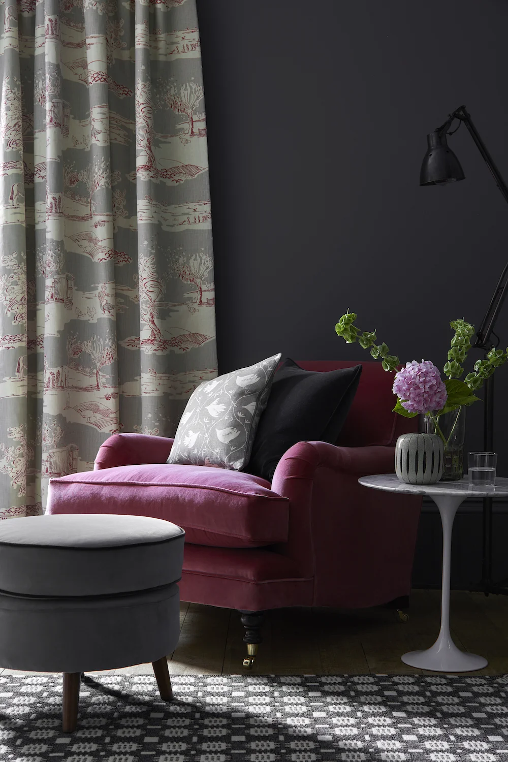 CURTAIN: For the Love of Rose Clay, Damson LOVE-37-45 £54/mtr; TRADITIONAL CHAIR: Rose Velvet VELVET-76 £58/mtr; CERNEY FOOTSTOOL: Elephant Velvet VELVET-75 £58/mtr piped in Thunder Velvet VELVET-74 £58/mtr; Cushion (back): Self piped and zipped Thunder Velvet VELVET-74 £58/mtr; CUSHION (front): Branching Out Scree BRANCH-67 £52/mtr piped in Plain Linen Charcoal PLAIN-38 £48/mtr; RUG: Dark Grey Tapestry by Solva Woolen Mill £99.75 each; PAINT: Scree 227 by Little Greene Paint Company £42, per 2.5 ltr