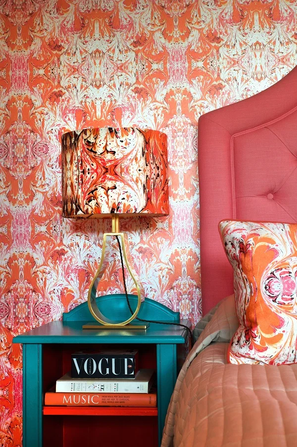 orange feathered wallpaper, lampshade and cushion