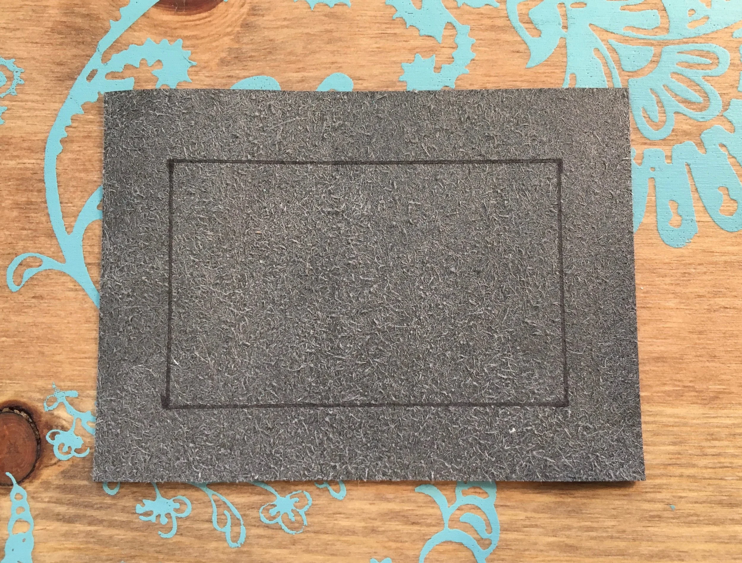 I was able to draw the rectangle for cutting out the center of the window pocket on the back of the faux leather (and on the cork) using my Frixion pen.