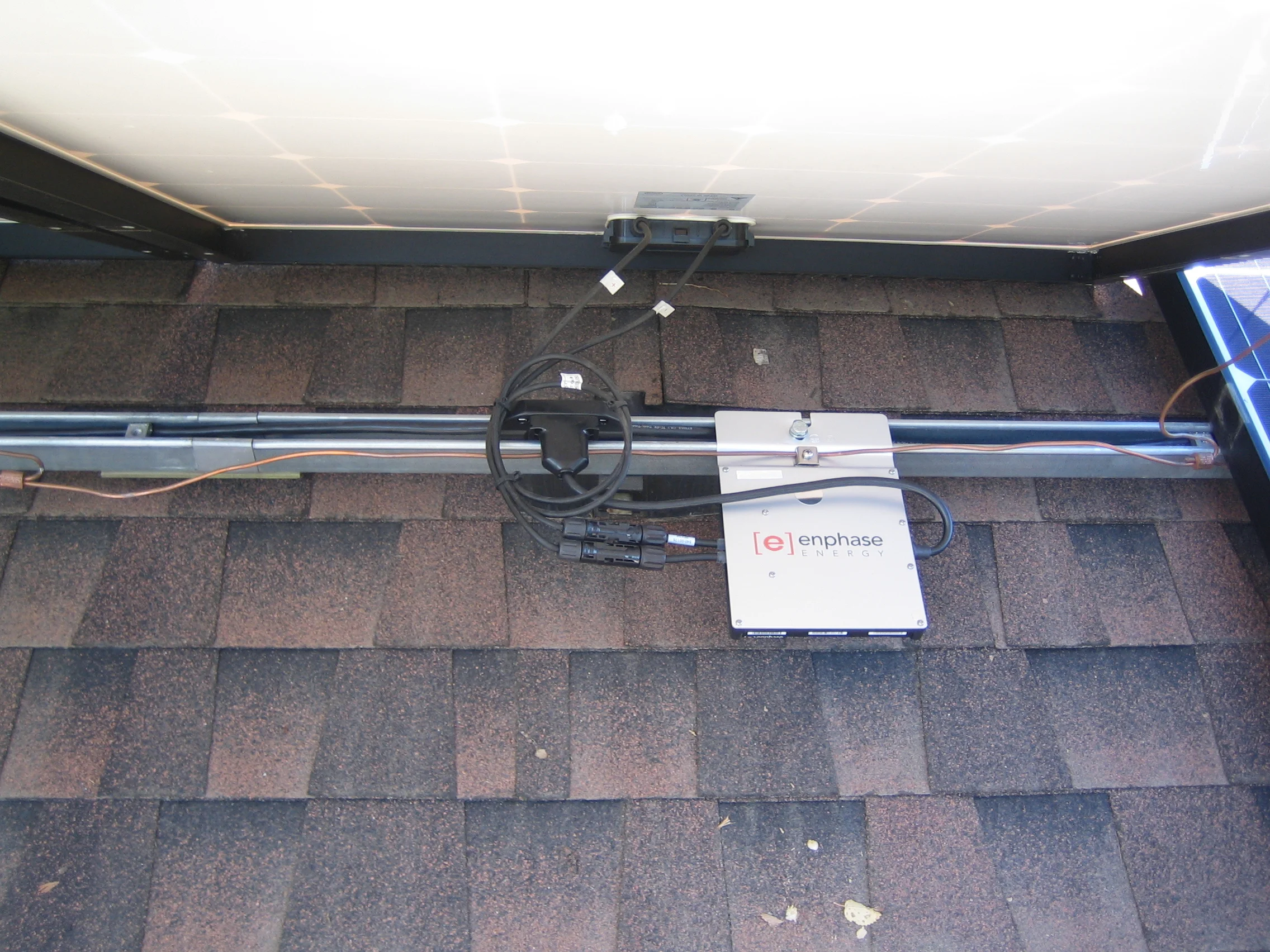 Solar PV panel connected to micro inverter, connected to racking rails