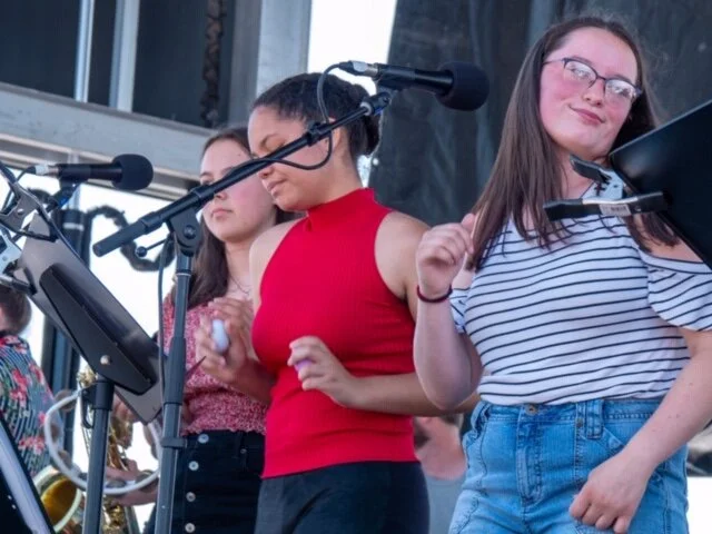 MCMA students Aili, Heather, and Alydia singing on the Main Stage at the North Atlantic Blues Festival. Photo credit: Pete Kalajian