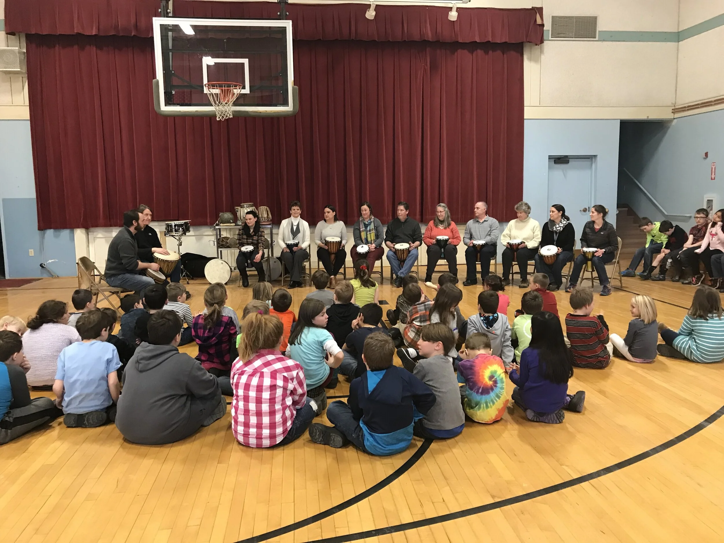 Tom Ulichny and Drew leading an interactive drum circle at a local elementary school.