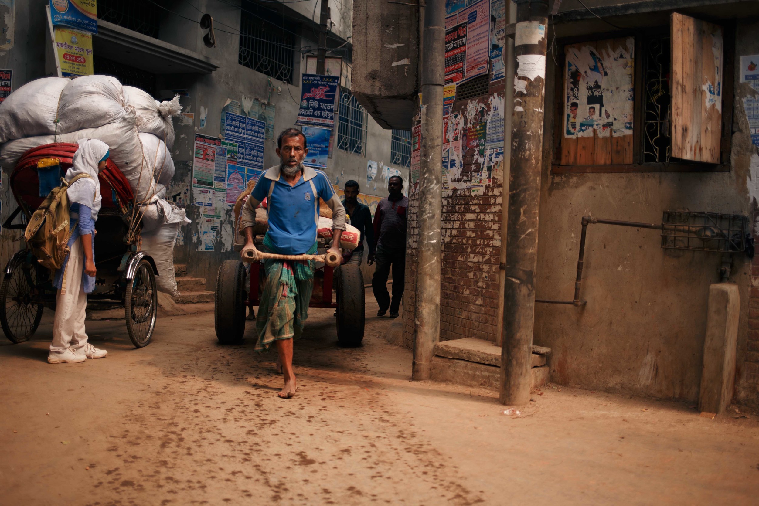  Local workers sprint back and forth from the factories transporting large volumes of leather by hand carts in the mid day heat. 