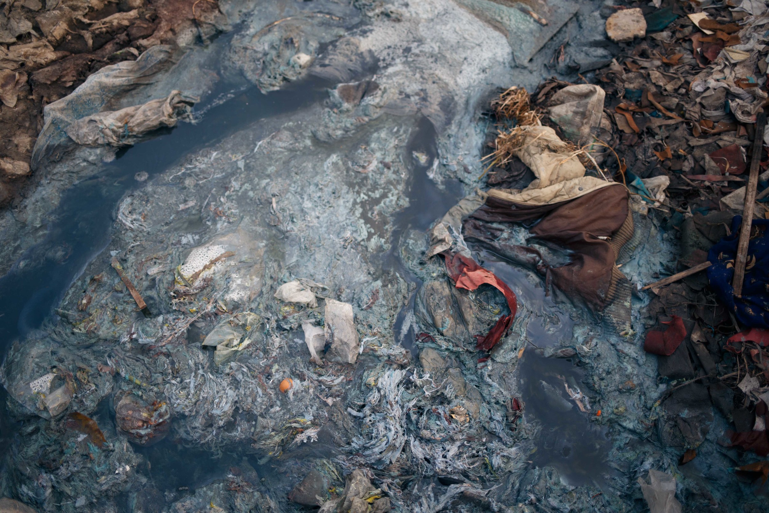  A closer look at the runoff water from the tanneries. Toxic water, plastic, animal and human waste, all flow together into the Buriganga. Residents of Hazaribagh fish in the river and ingest some of the chemicals released by the tanneries elevating 