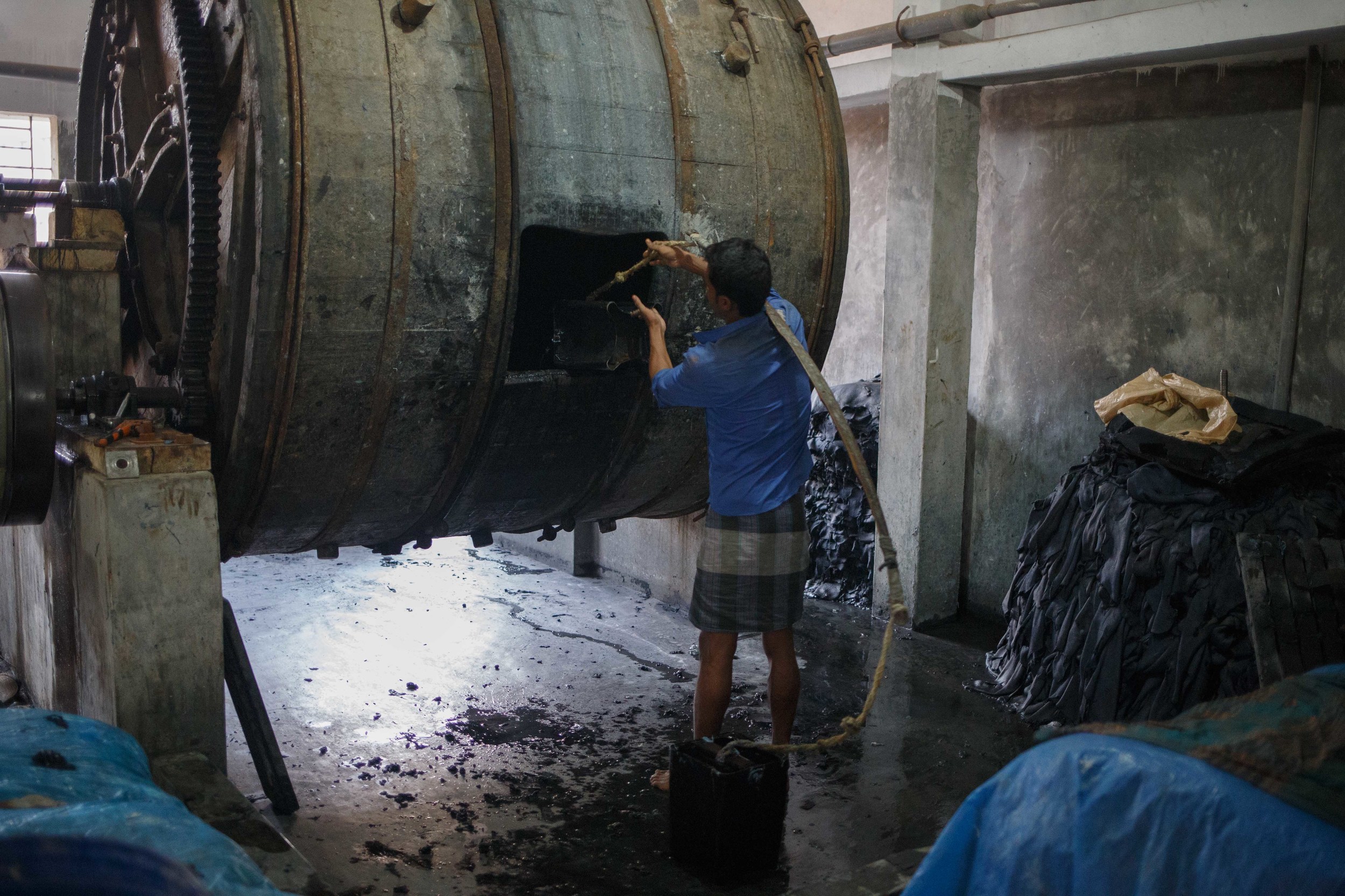  A man dumps chromium laden industrial strength bleach into one of the steel drums without any form of protection. 