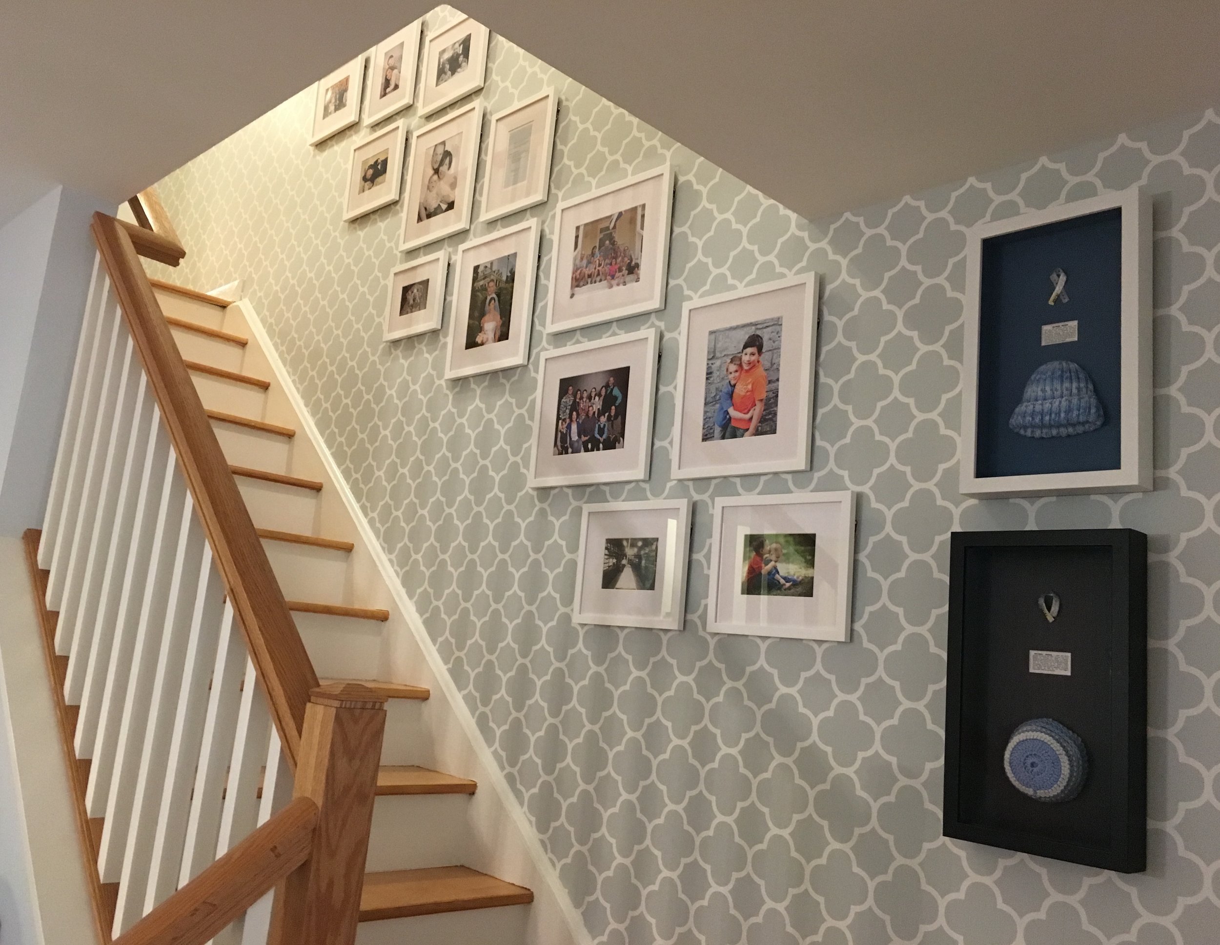 Framed family portraits going up the staircase