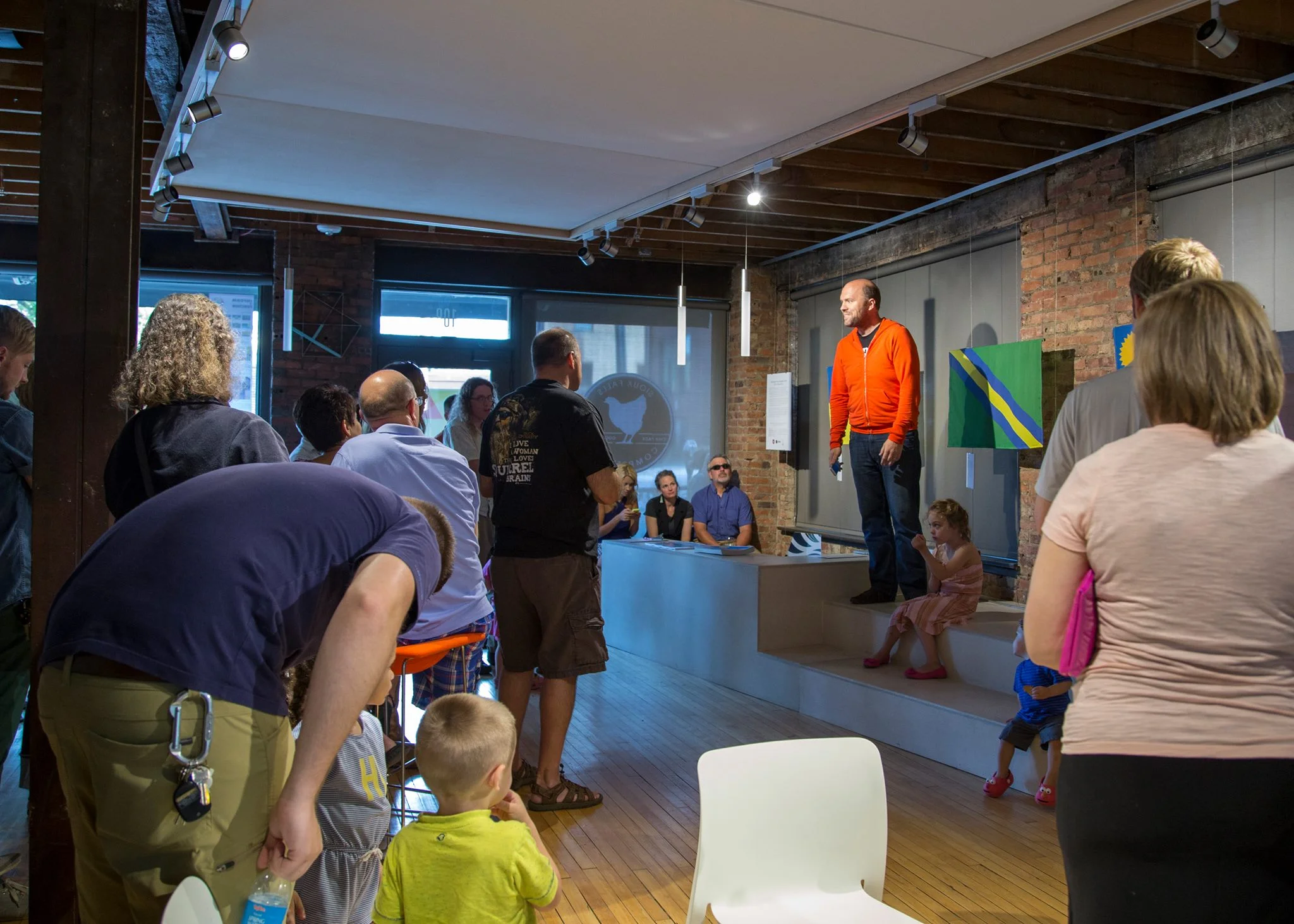 The Community of Sioux Falls reviews the Top 6 flags at the Sioux Falls Design Center gallery showing in August 2014.