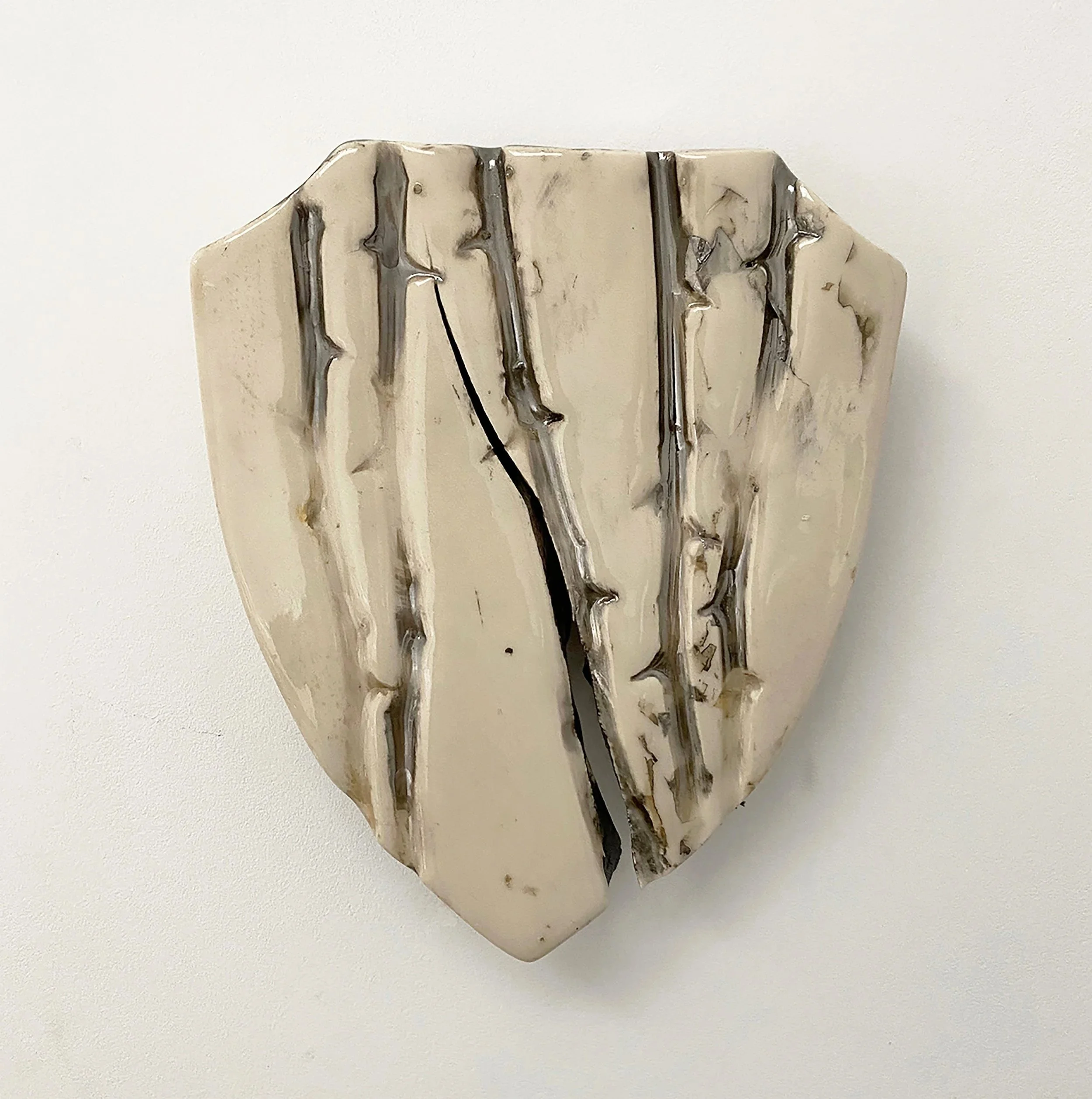 Winter Winds, a small ceramic wall sculpture by Lorna Stevens finished with silver nitrate and lacquer.