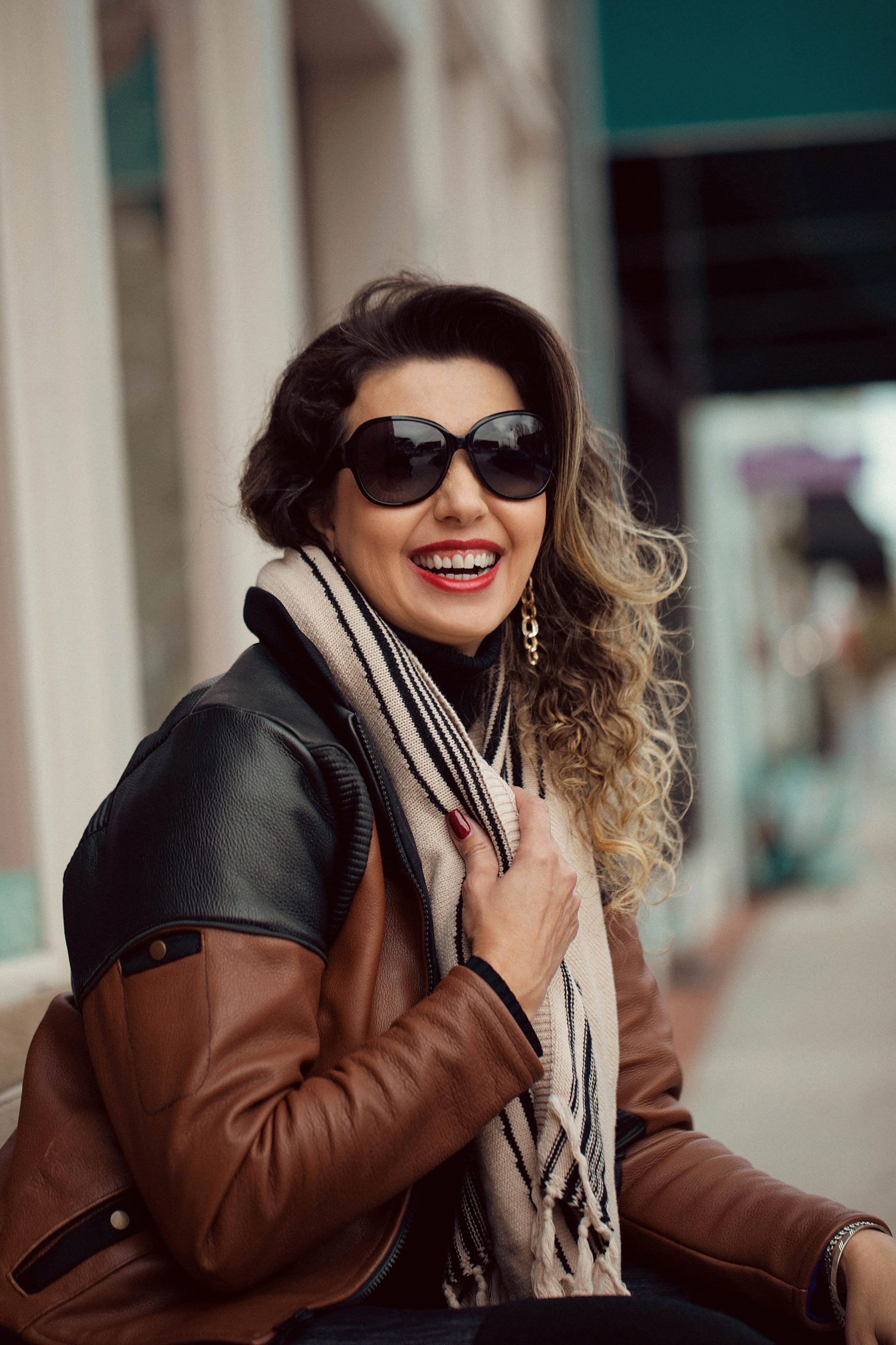 Chic-Riot-Irany-Cairo-Moto-Jacket-Downtown-Duluth-Sitting-Smiling.jpg