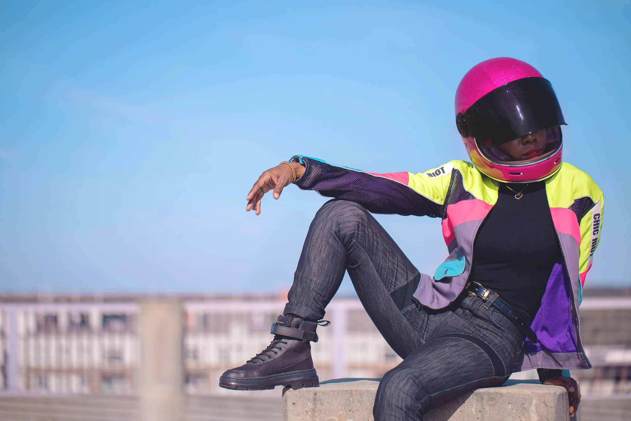 Chic-Riot-Kahling-Moto-Jacket-Sitting-On-Wall-Pink-Torc-Helmet-Downtown-Athens-Parking-Deck.jpg