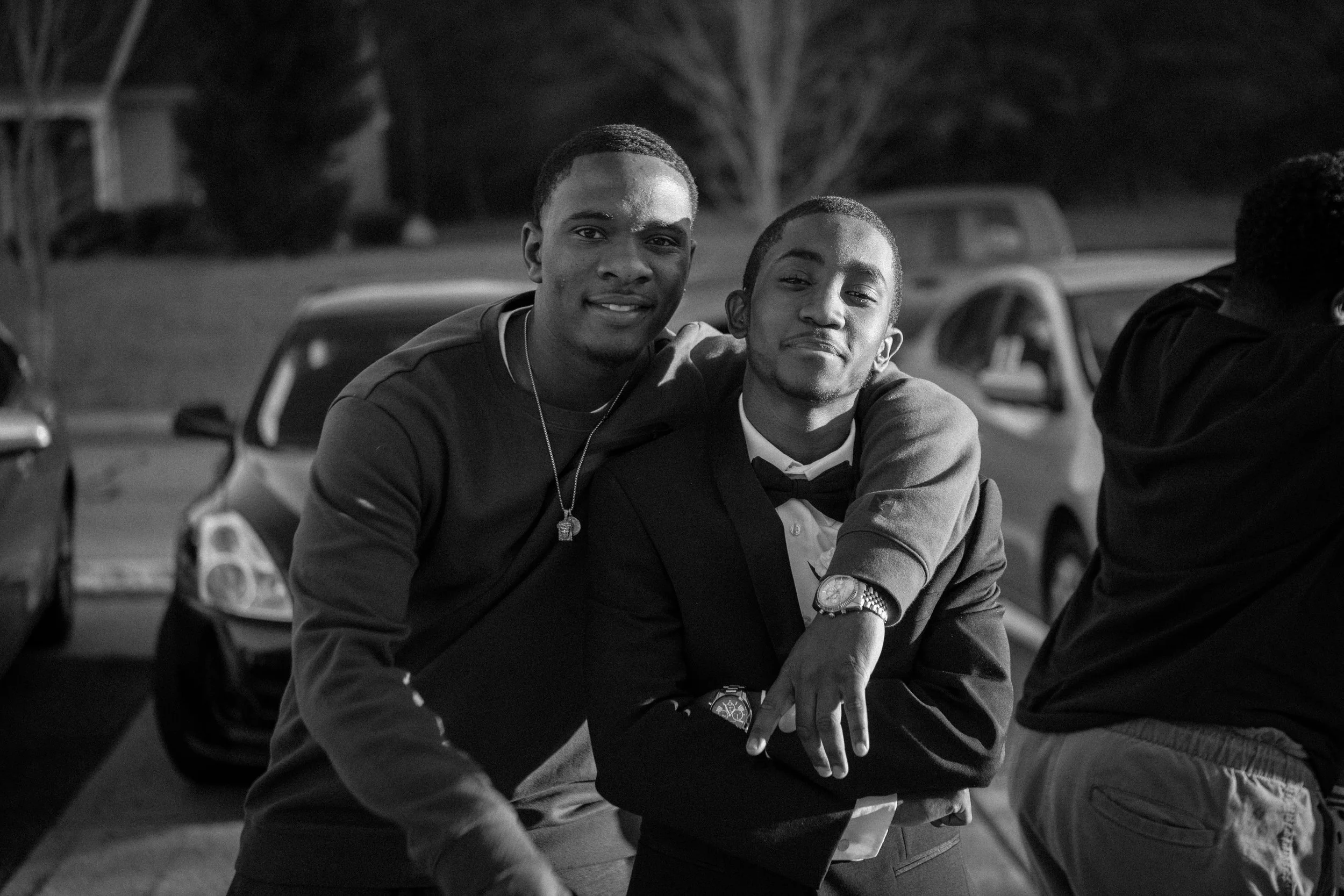 Two young men outside embracing