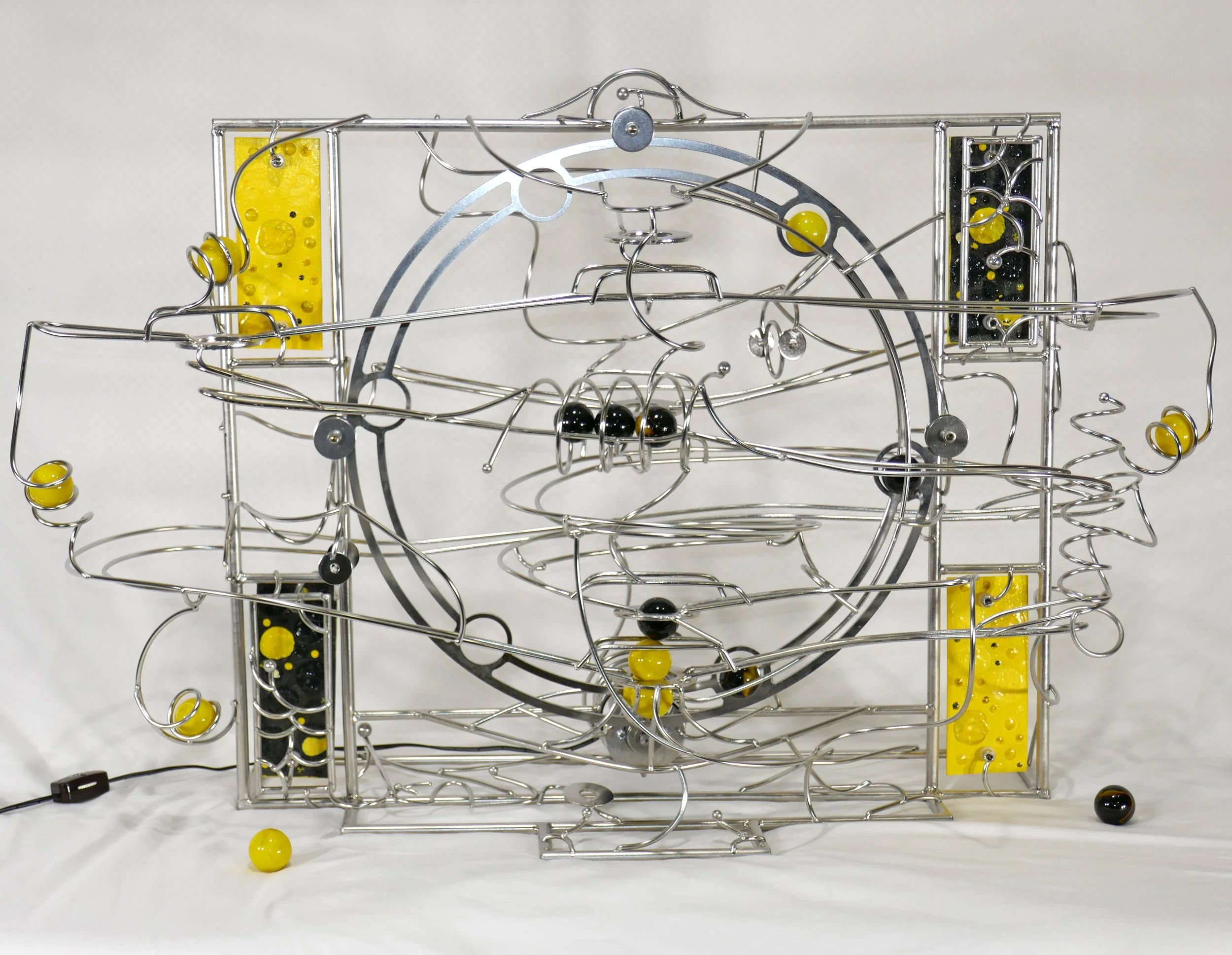 Rolling ball marble machine - Yellow and black marbles - named Orpiment - front view