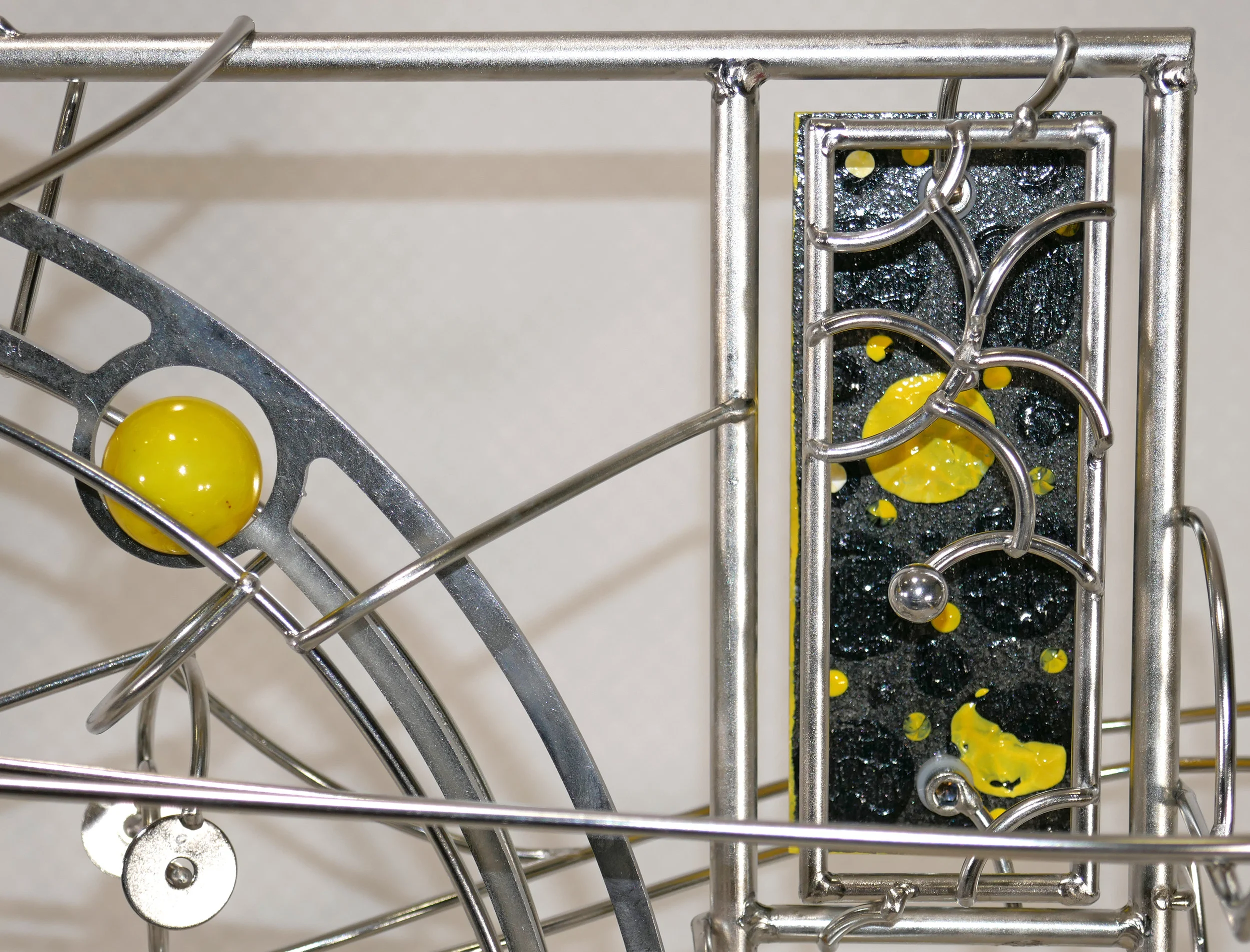 Rolling ball marble machine - close up of ring lift carrying the marble to the top