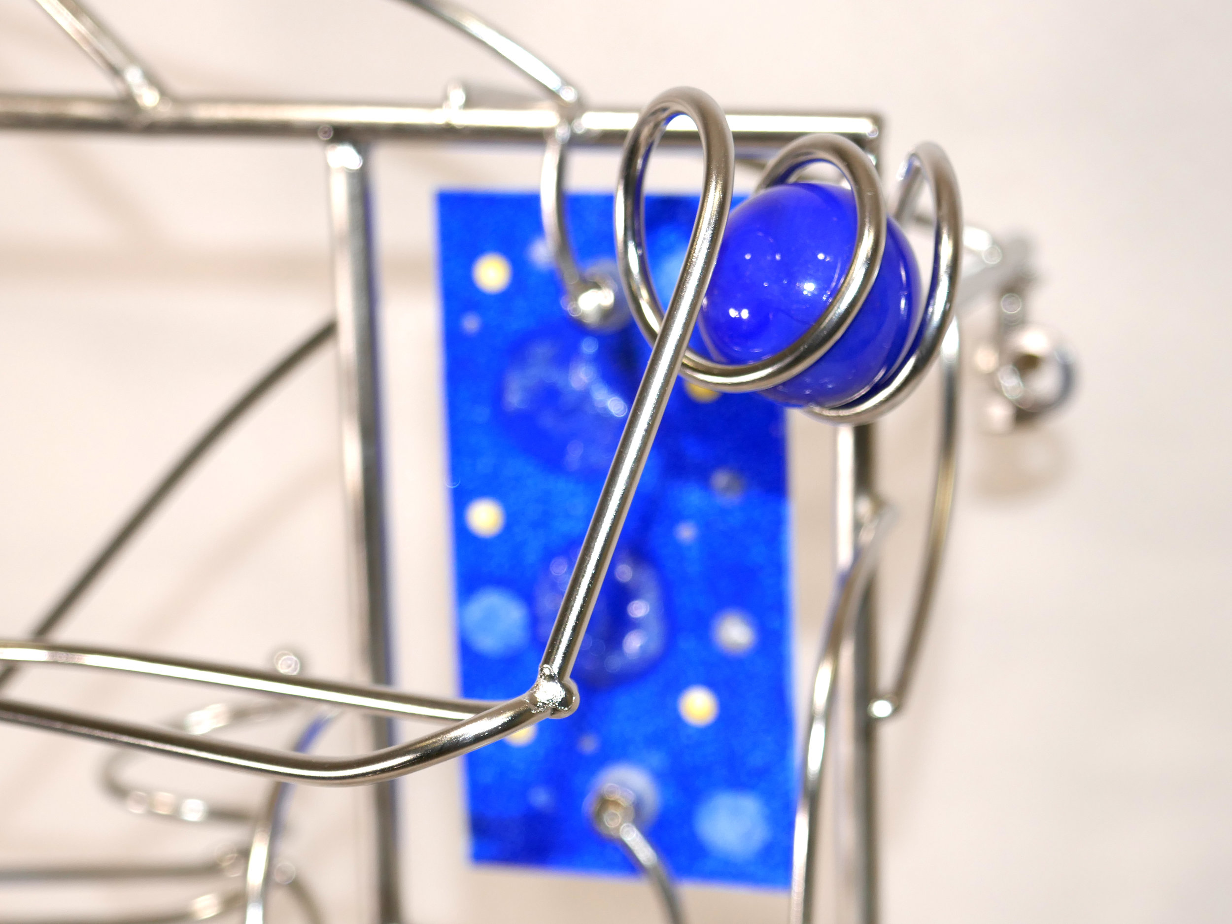 Rolling ball marble machine - close up of blue marble detail