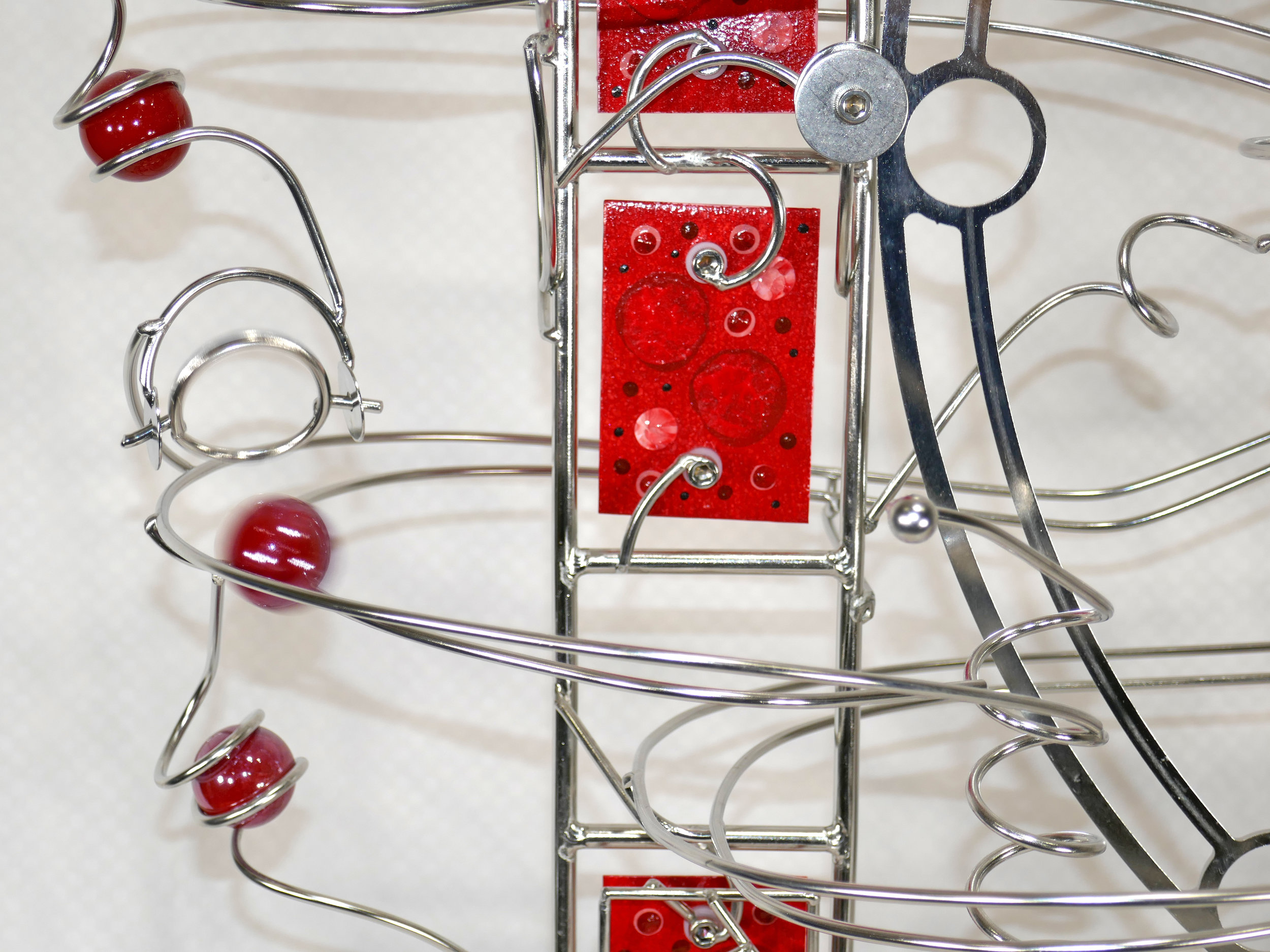 Rolling ball marble machine - close up of red marble details