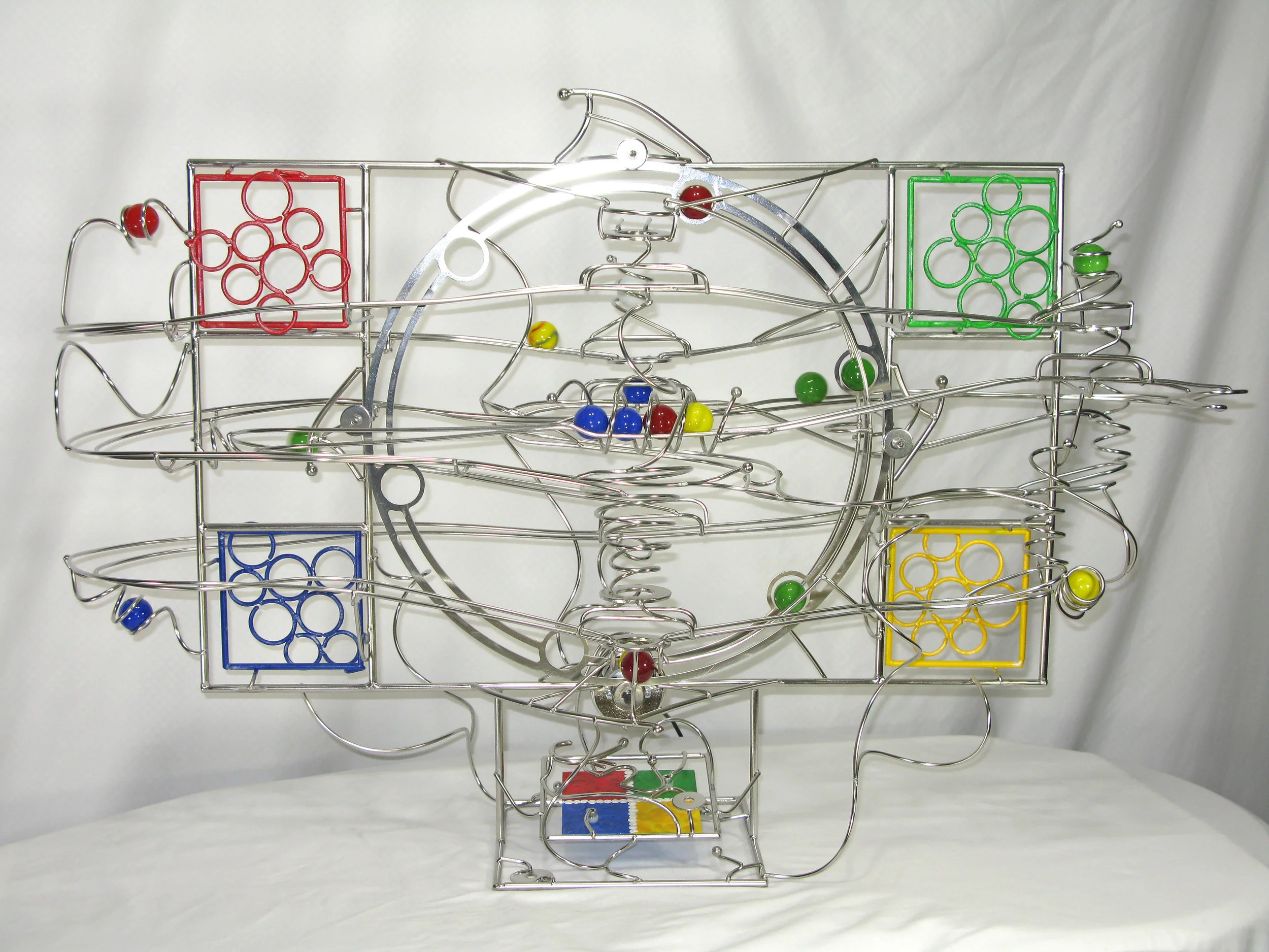 Rolling Ball Sculpture - kinetic art front view of Empower - a Microsoft logo themed work
