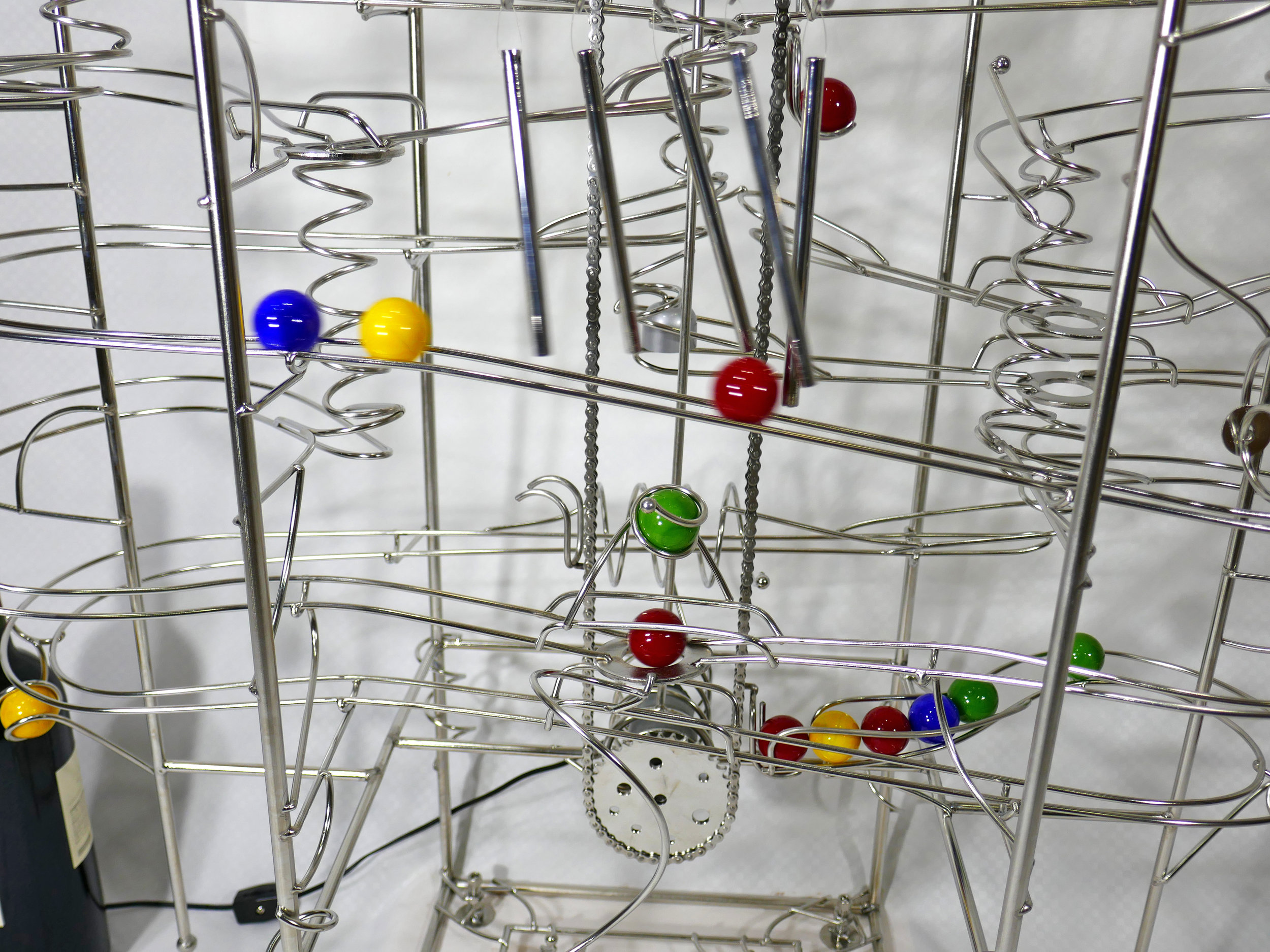Rolling ball marble run machine - close up of marbles striking the hand made chimes - Stephen Jendro