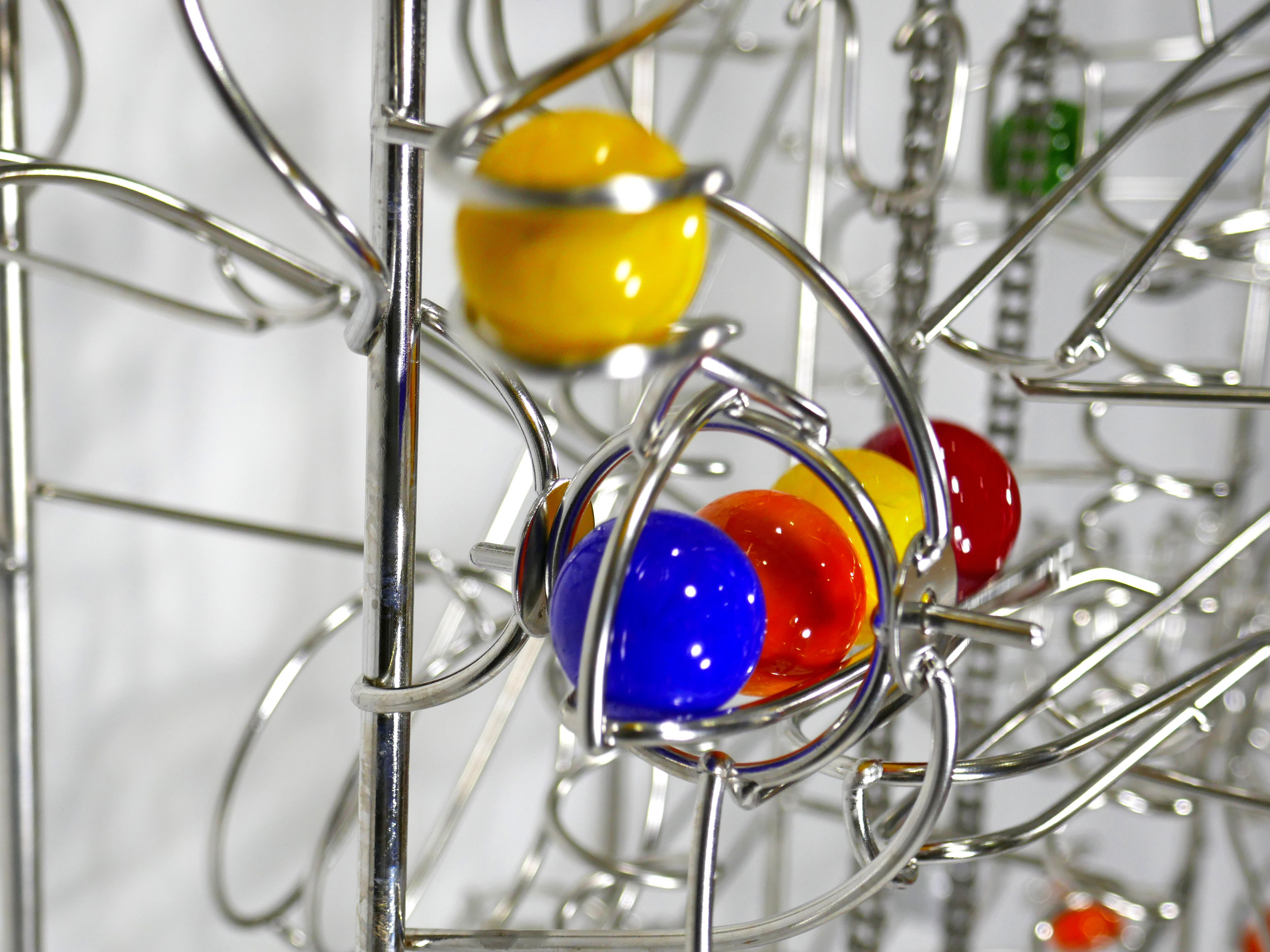 Rolling ball marble run sculptures - close up of ball drop kinetic element - Stephen Jendro