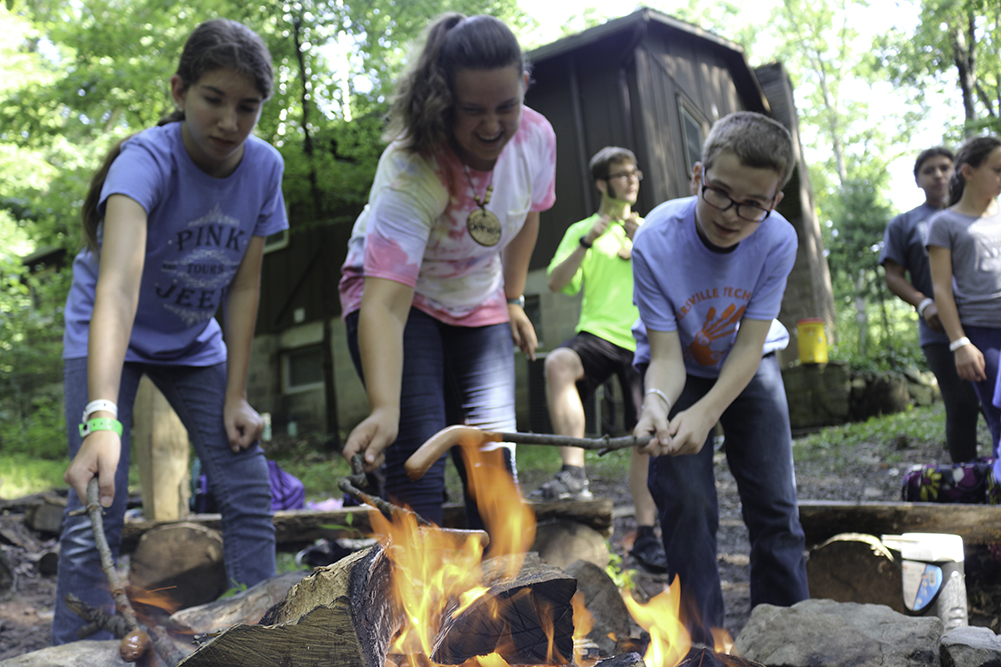 Many campers enjoyed hot dogs over the fire this summer. 