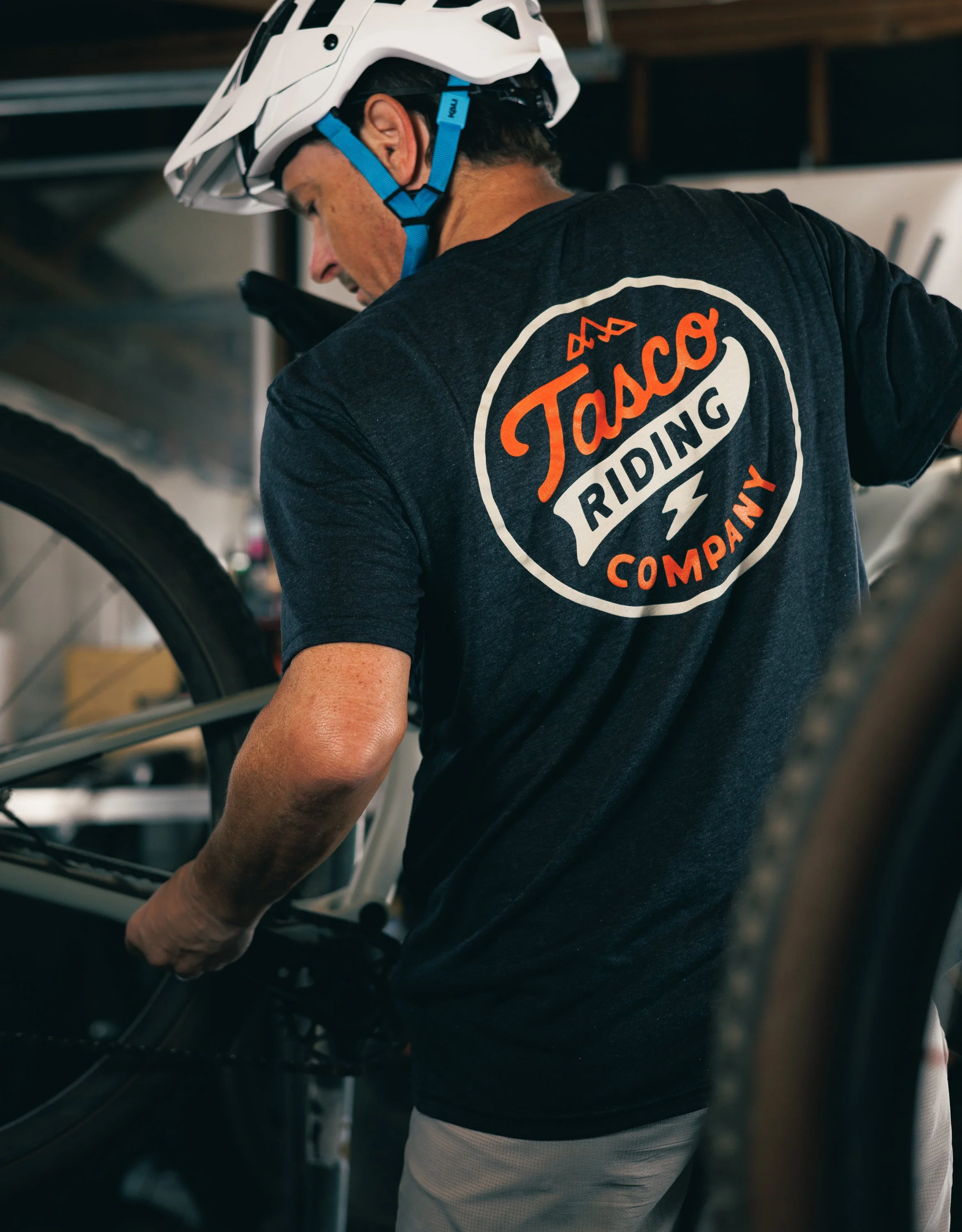 lifestyle photography of rider tuning bike in garage