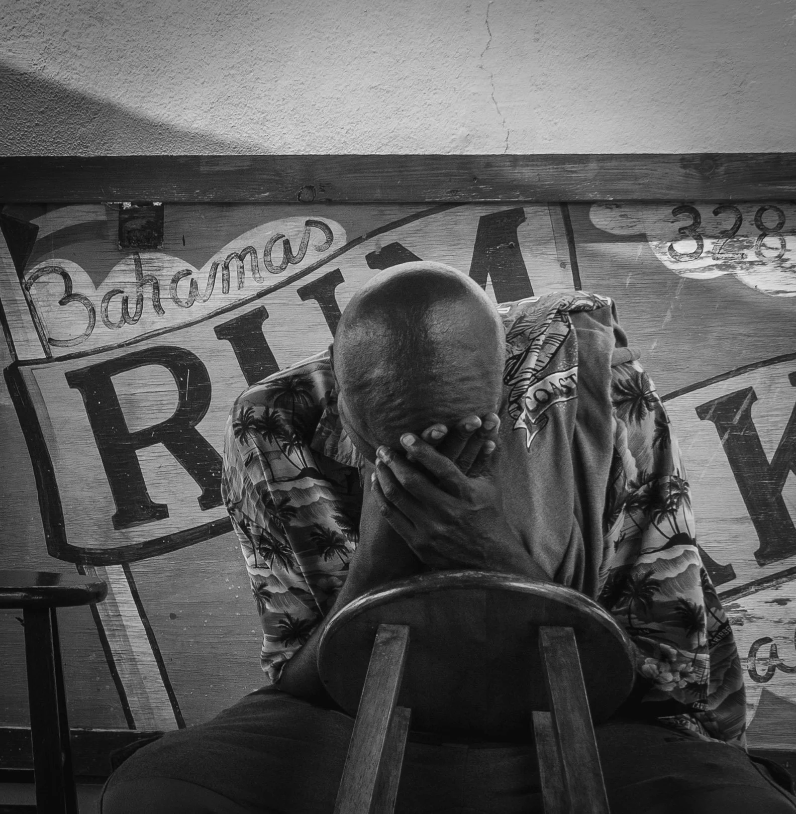 documentary photography of worker at the rum cake factor in Bahamas