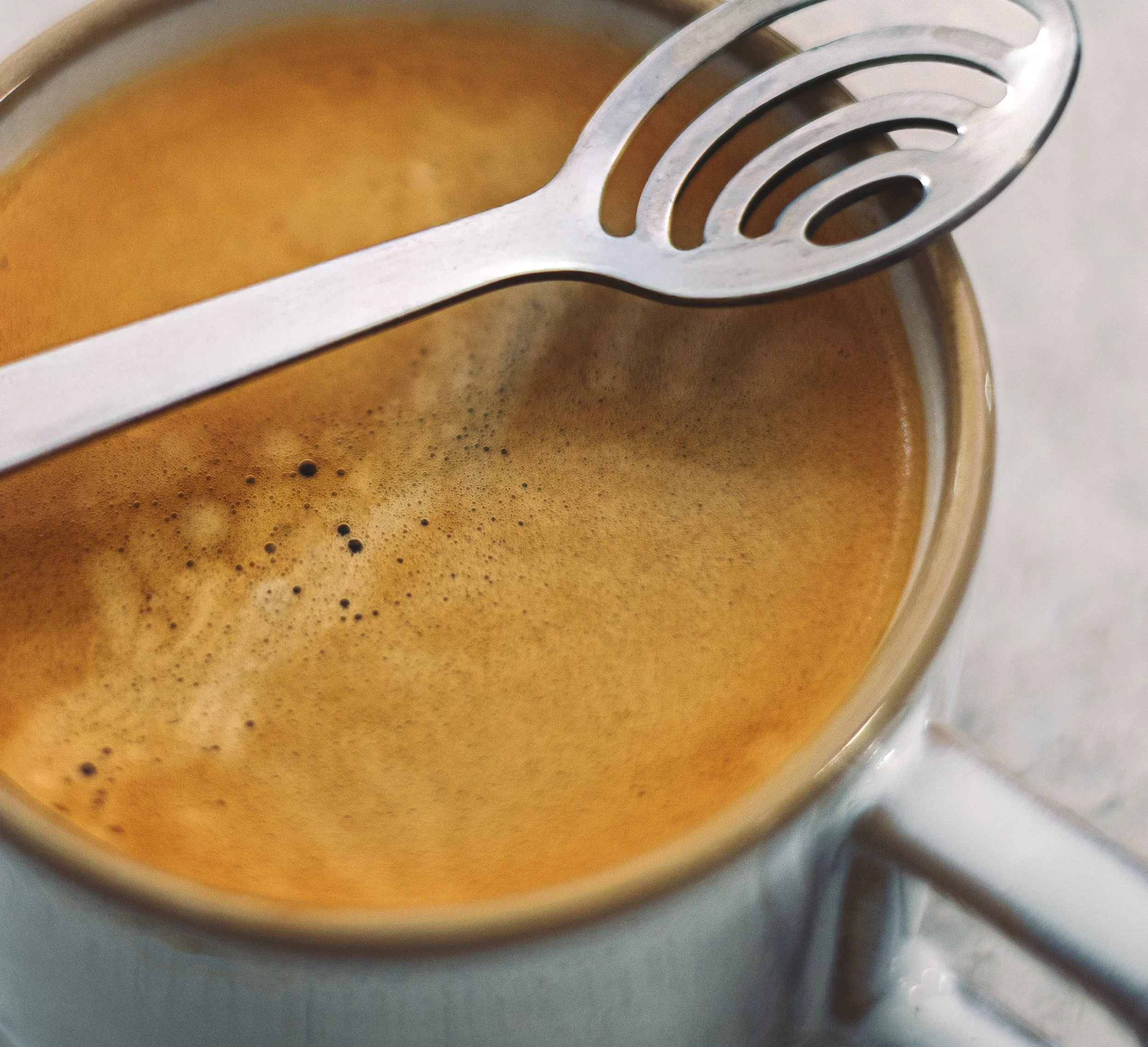 detail of espresso and stirring spoon