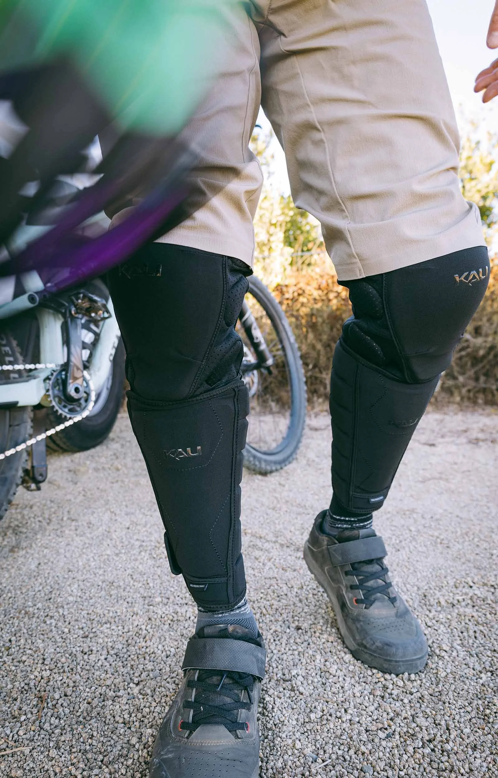 lifestyle photo of rider putting on mountain bike protective gear