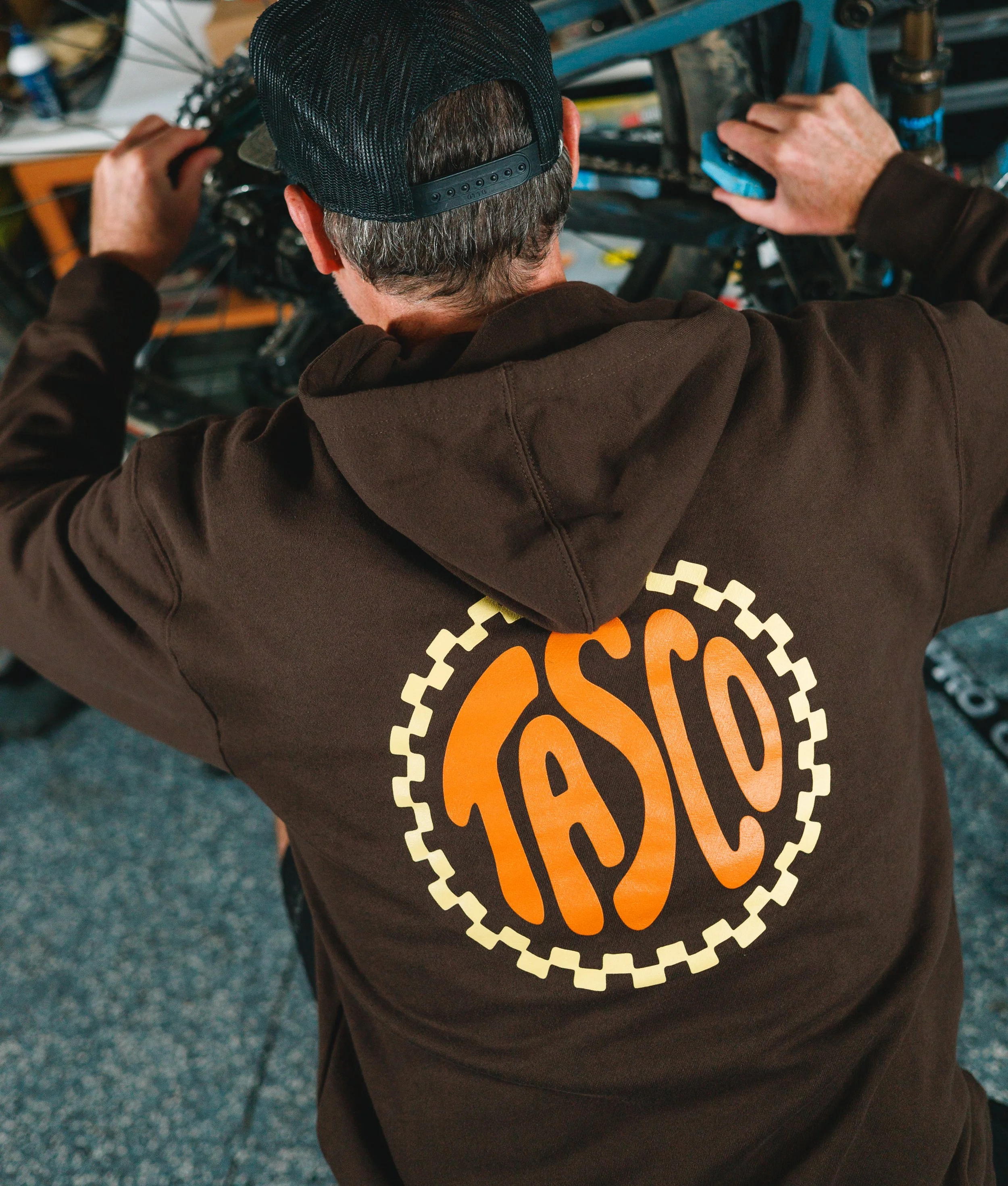 lifestyle photo of mountain biker working on bike