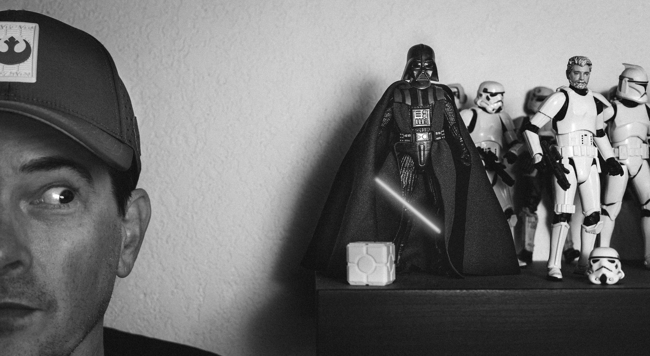 close up of Tim Vangilder looking at Star Wars action figure collection