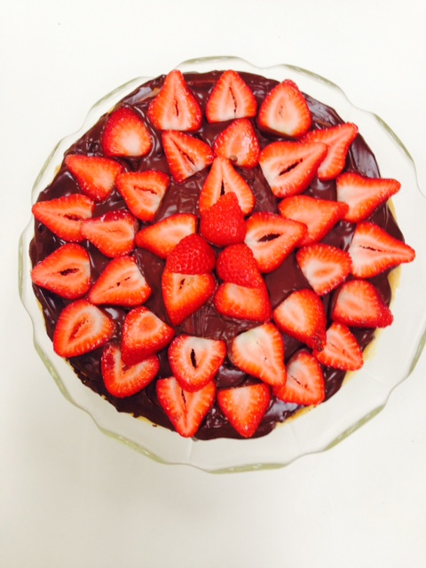 cheesecake with chocolate ganache and strawberries