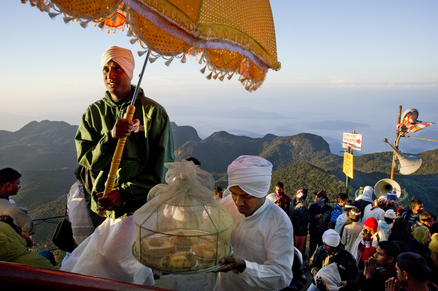  Pilgrims carrying offerings to the top of Adam's peak, a holy site for Sri Lankans of all faiths. While Buddhists believe the rock to be imprinted with the Buddha's footprint, Christians consider the footprint to be of St. Thomas and Muslims see it 