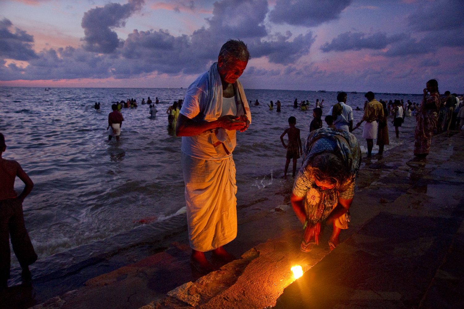  Hindu pilgrims making an offering outside Rameswaram's Ramanathaswamy temple, just before sunrise. Most Hindus believe that Hanuman and his army of monkeys built a bridge from this point in India to Sri Lanka to retrieve the kidnapped bride of Rama.