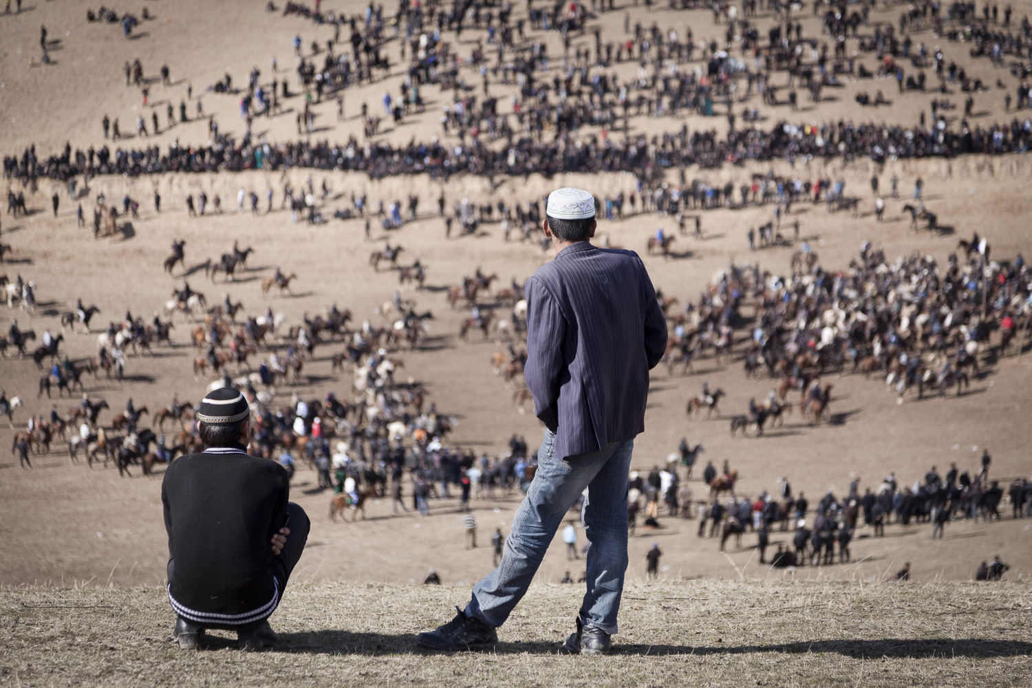  Young spectators view a horde of buzkashi horses from a nearby hill in Dangara, southern Tajikistan. 