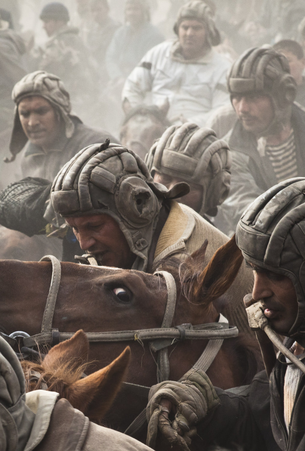  Buzkashi players fight for possession of a goat carcass in Sharinav, Tajikistan. 