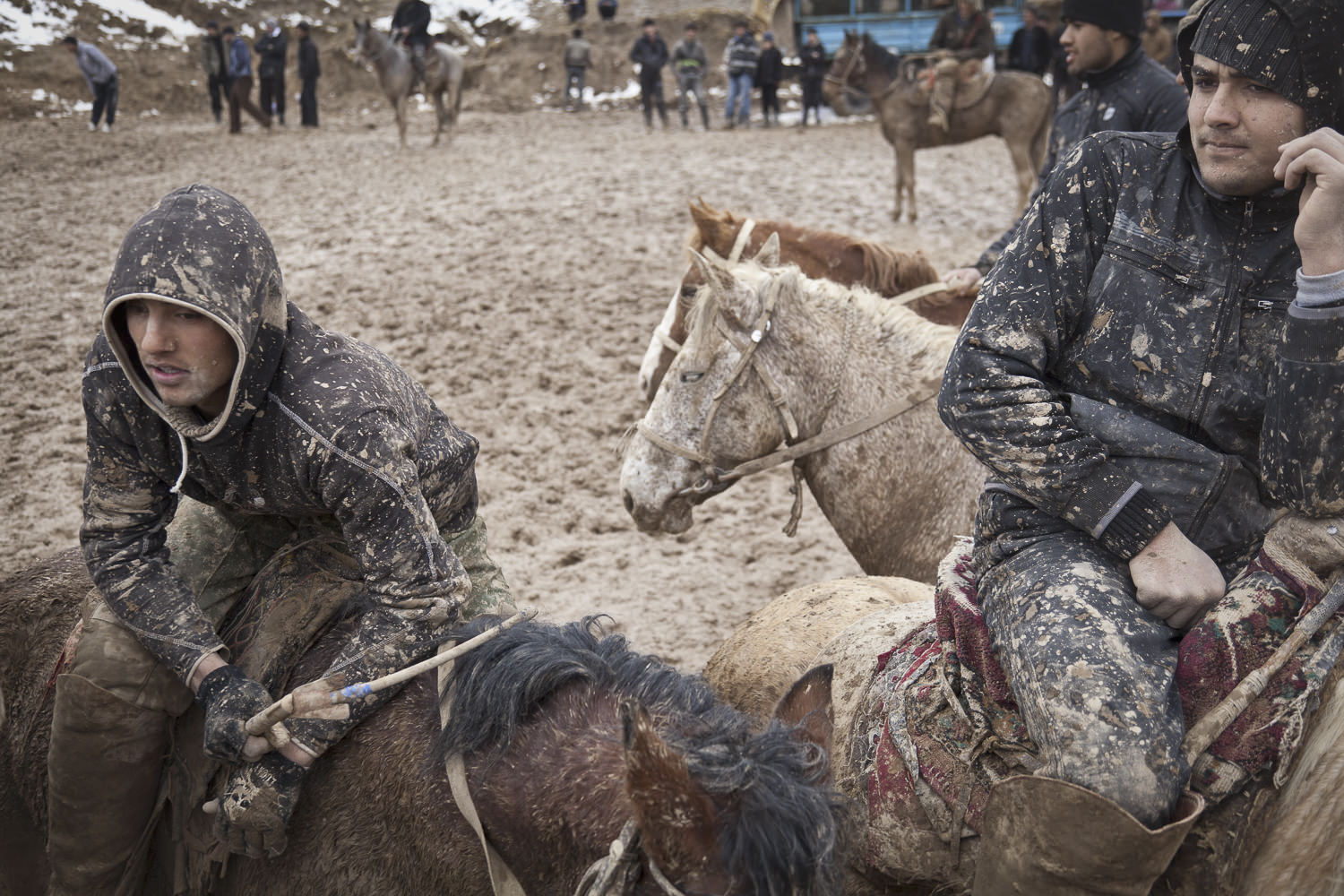  Tired buzkashi playing youths take rest during a muddy match. Popular throughout much of Central Asia, buzkashi is a form of horse polo in which horseback players wrestle a goat carcass across a playing field. 