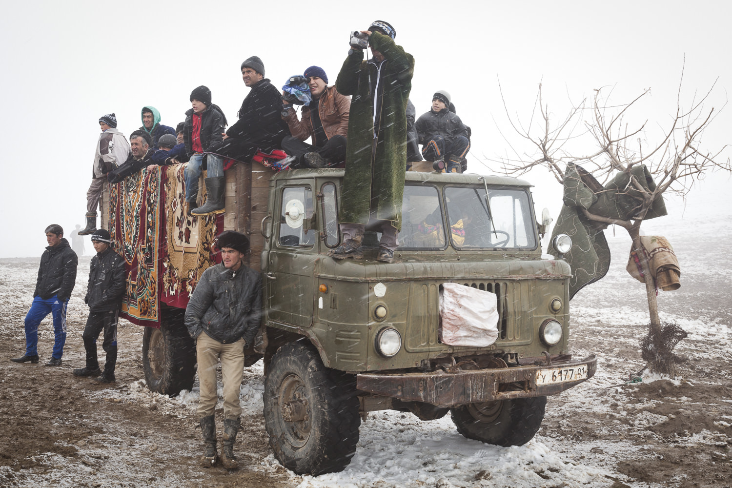  Buzkashi fans cluster around a truck holding competition prizes. 