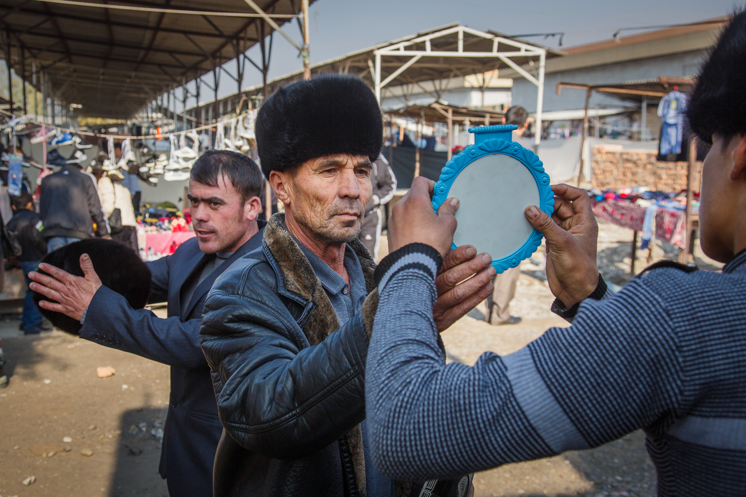  Trying on hats in Margilan, Uzbekistan 