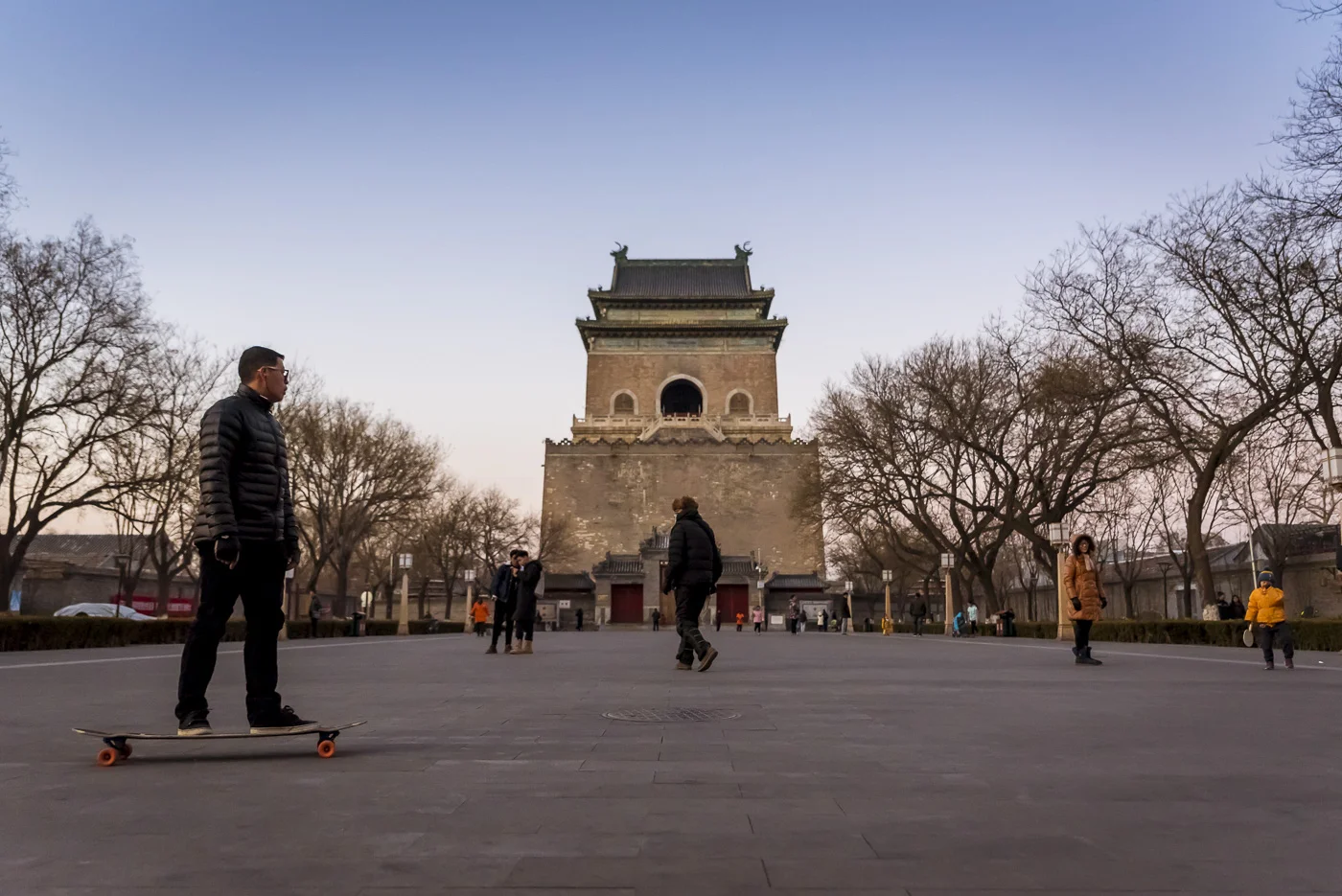 Guy on a skateboard in front of Zhonglou or Bell Tower, Beijing, China © Dosfotos
