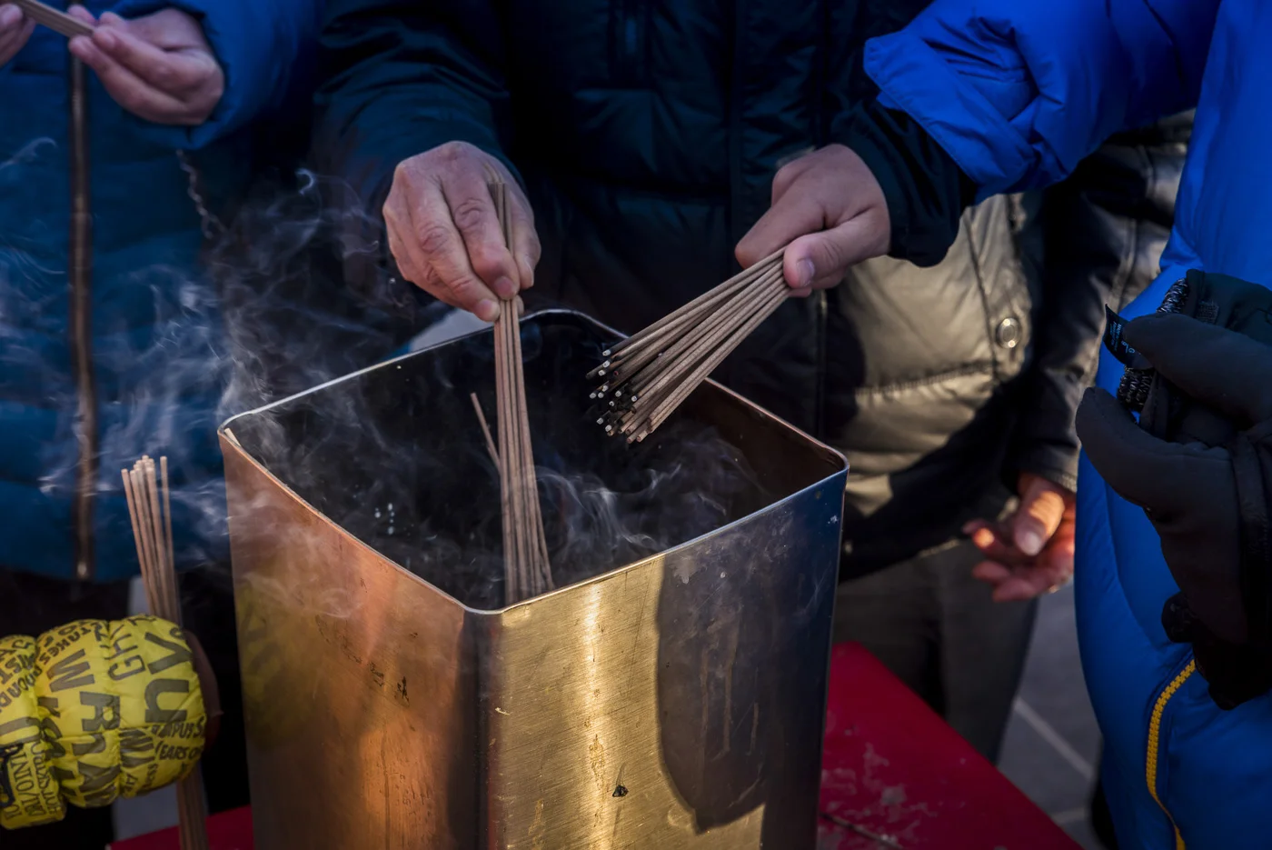 Burning incense at the Lama Temple, Dongcheng District, Beijing, China © Dosfotos