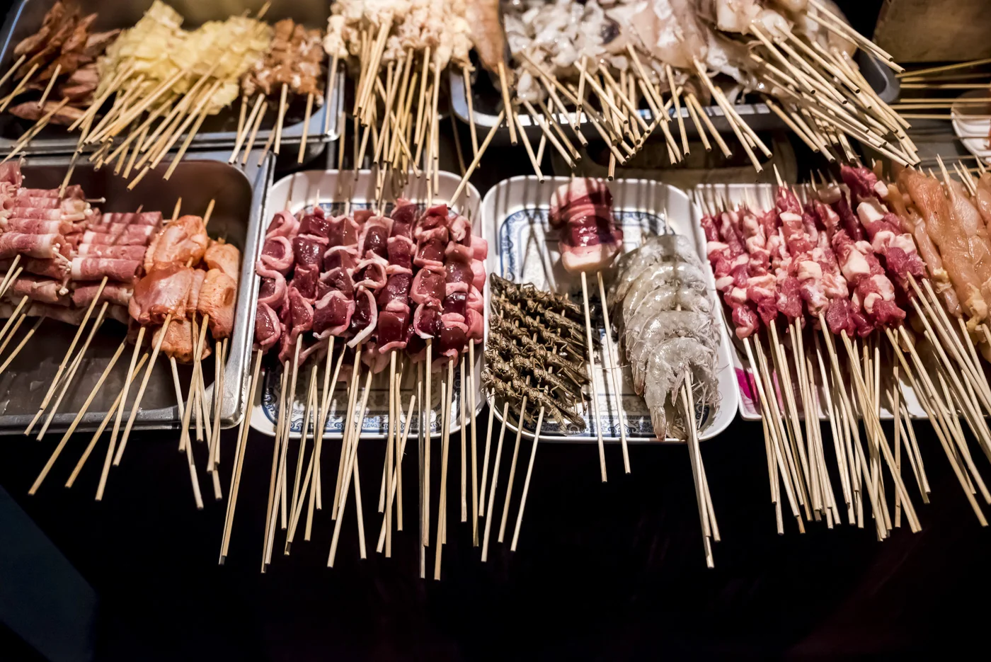 Street vendor with skeewers ready to be cooked in Beijing, China © Dosfotos