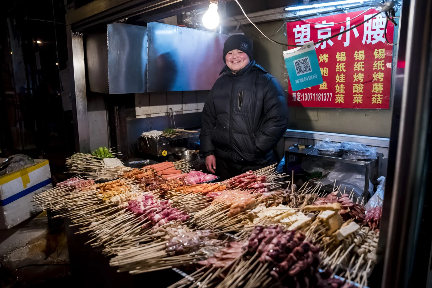 Street vendor with skeewers ready to be cooked in Beijing, China © Dosfotos