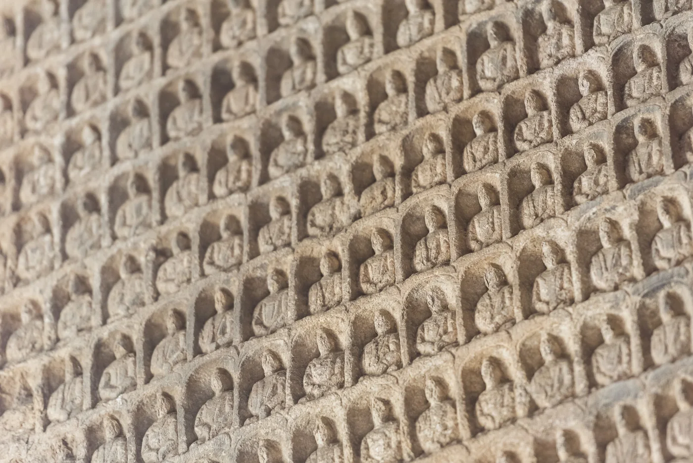 Miniature carved Buddhist statues at Yungang Grottoes, ancient Chinese Buddhist temple grottoes near Datong, China © Dosfotos