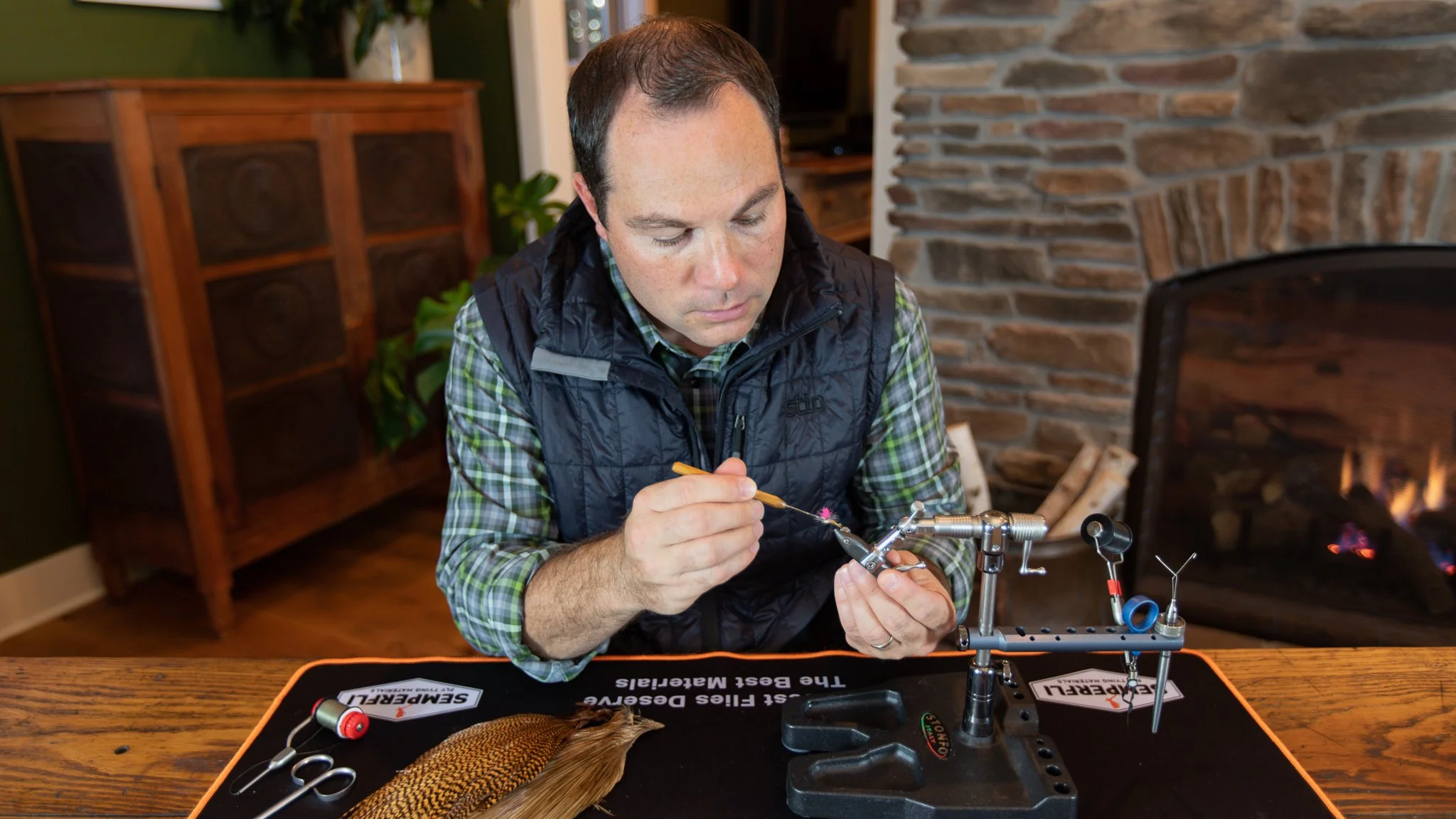 Tim tying a fly at his bench using fly tying tools